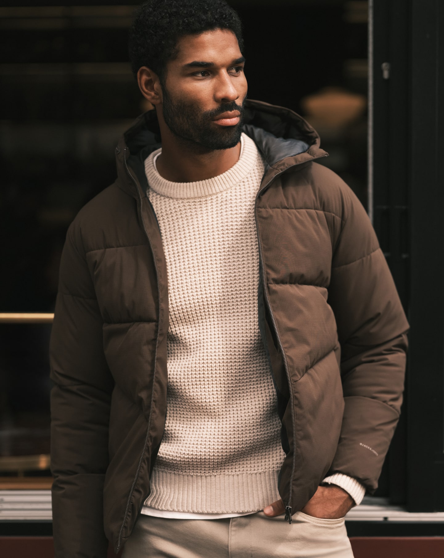 Model wearing khaki Jack & Jones puffer jacket