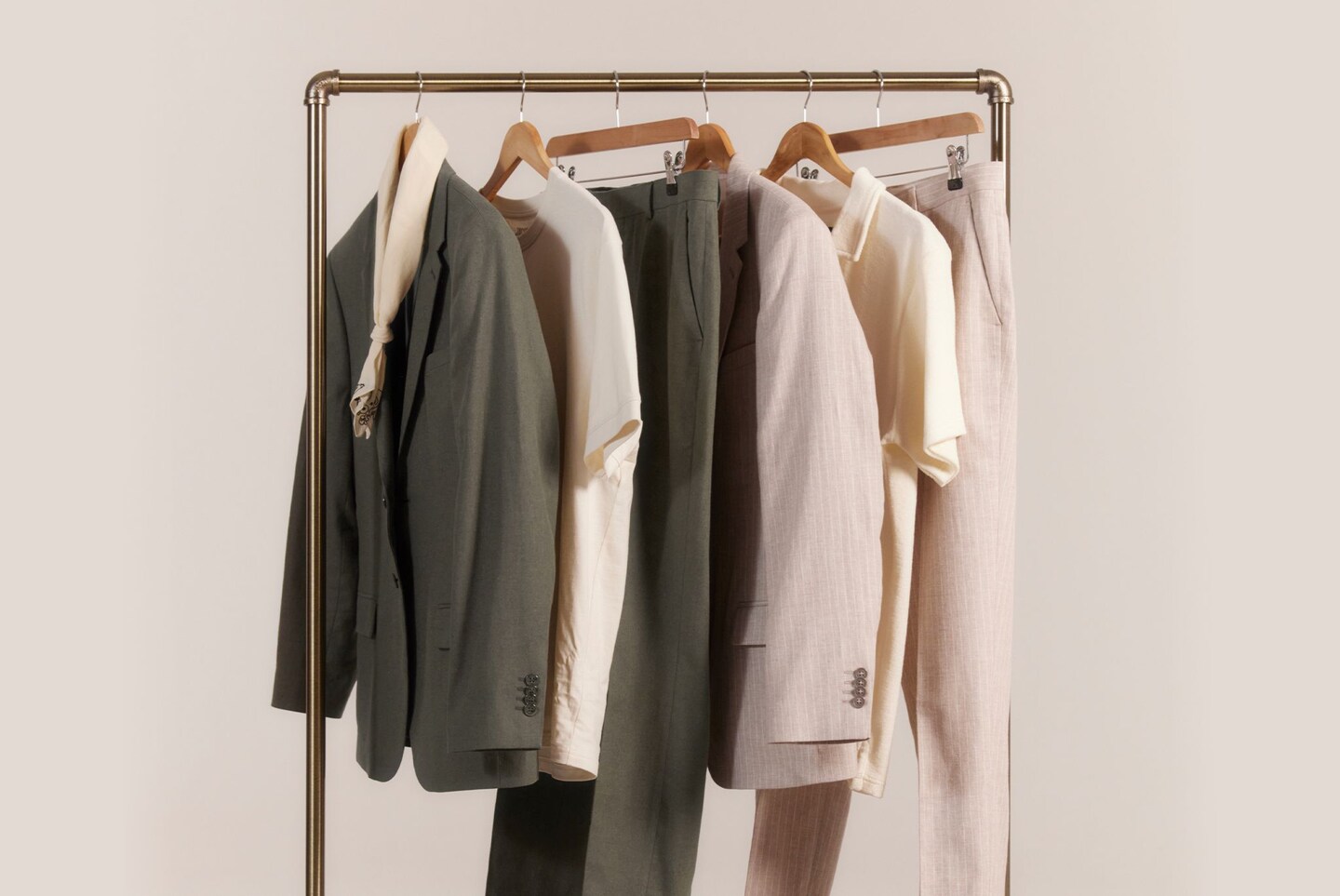 Clothing rail with a variation of grey and beige smart suit separates