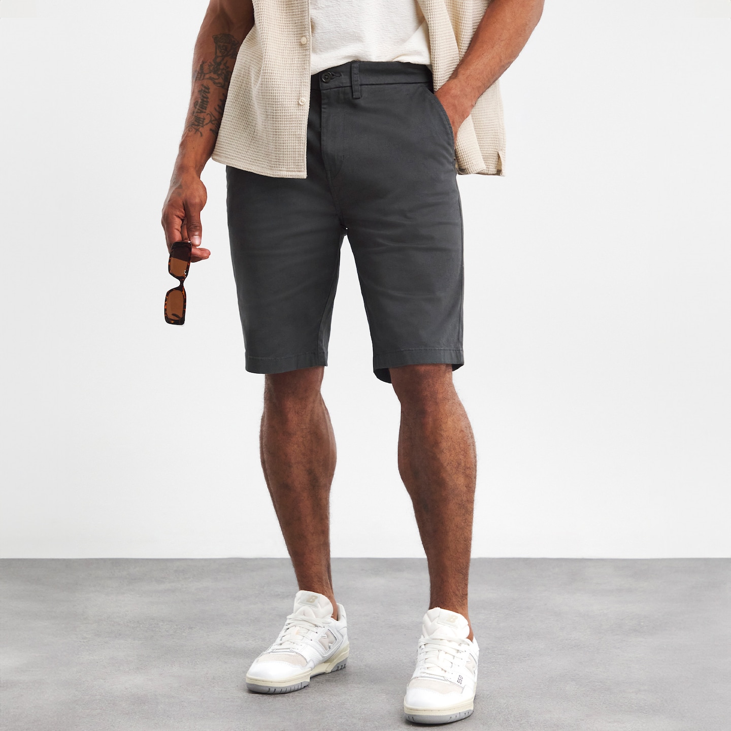 Model wearing grey shorts