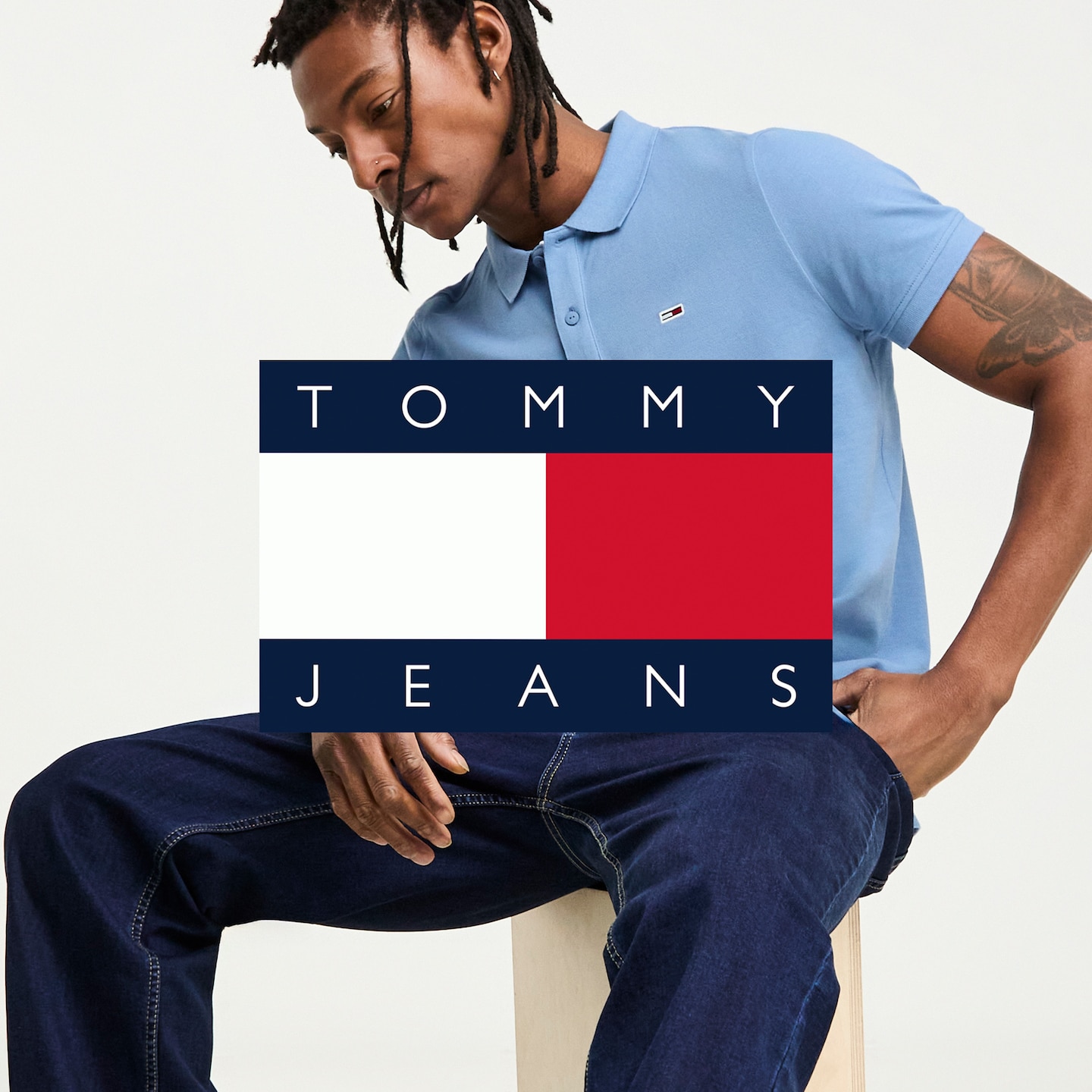 Model wearing a blue Tommy Jeans polo 