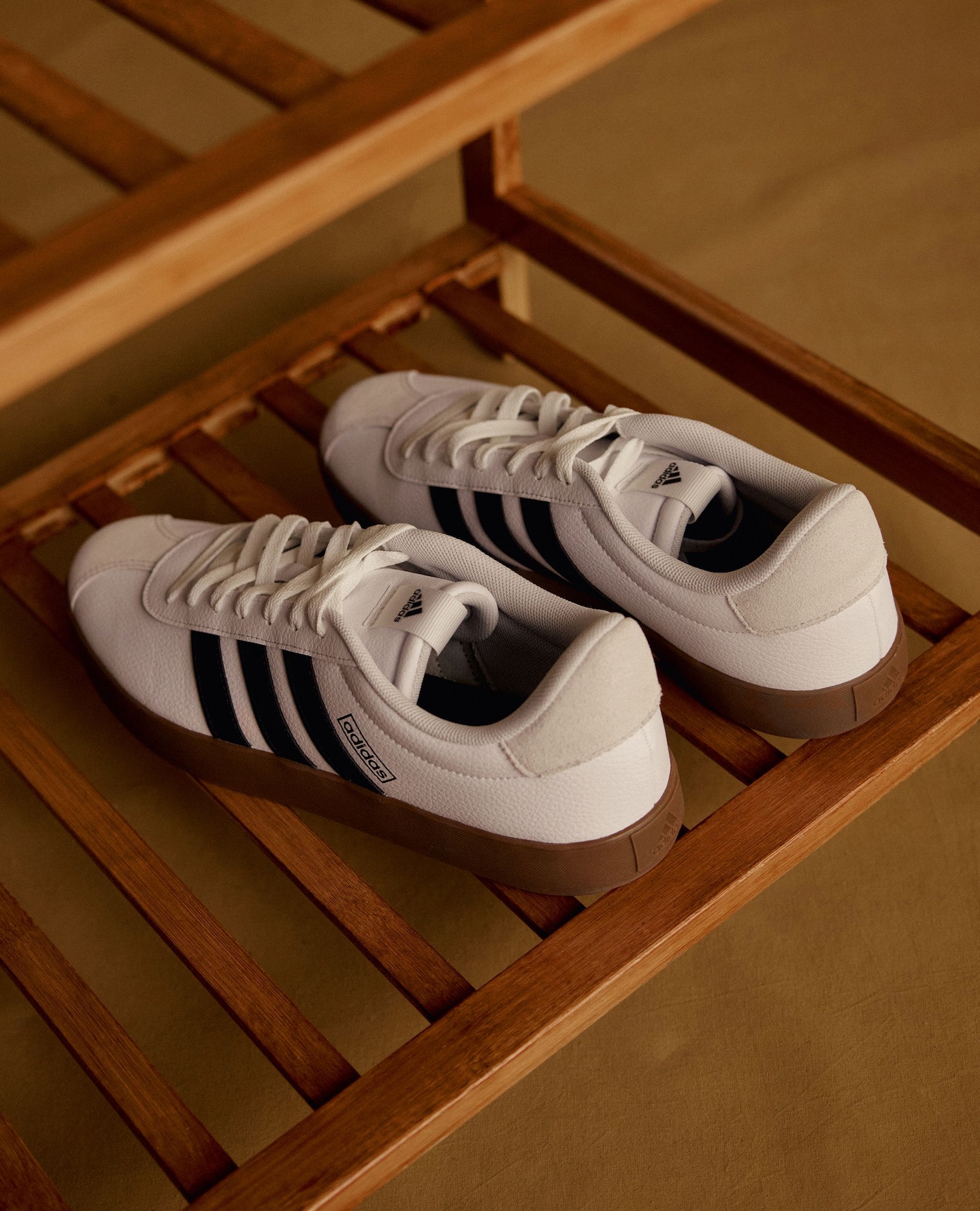 Black & white adidas trainers displayed at a gym
