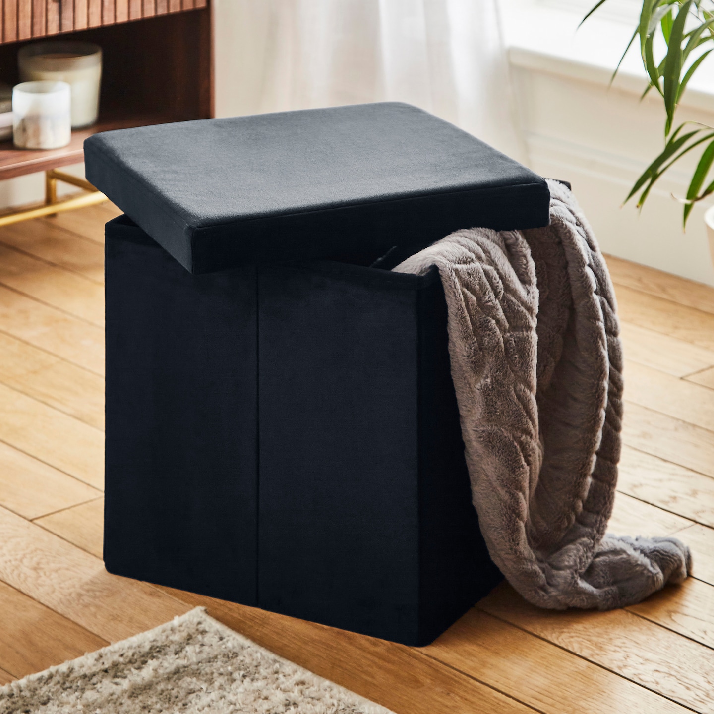 Velvet Foldable Storage Ottoman Cube pictured with brown throw