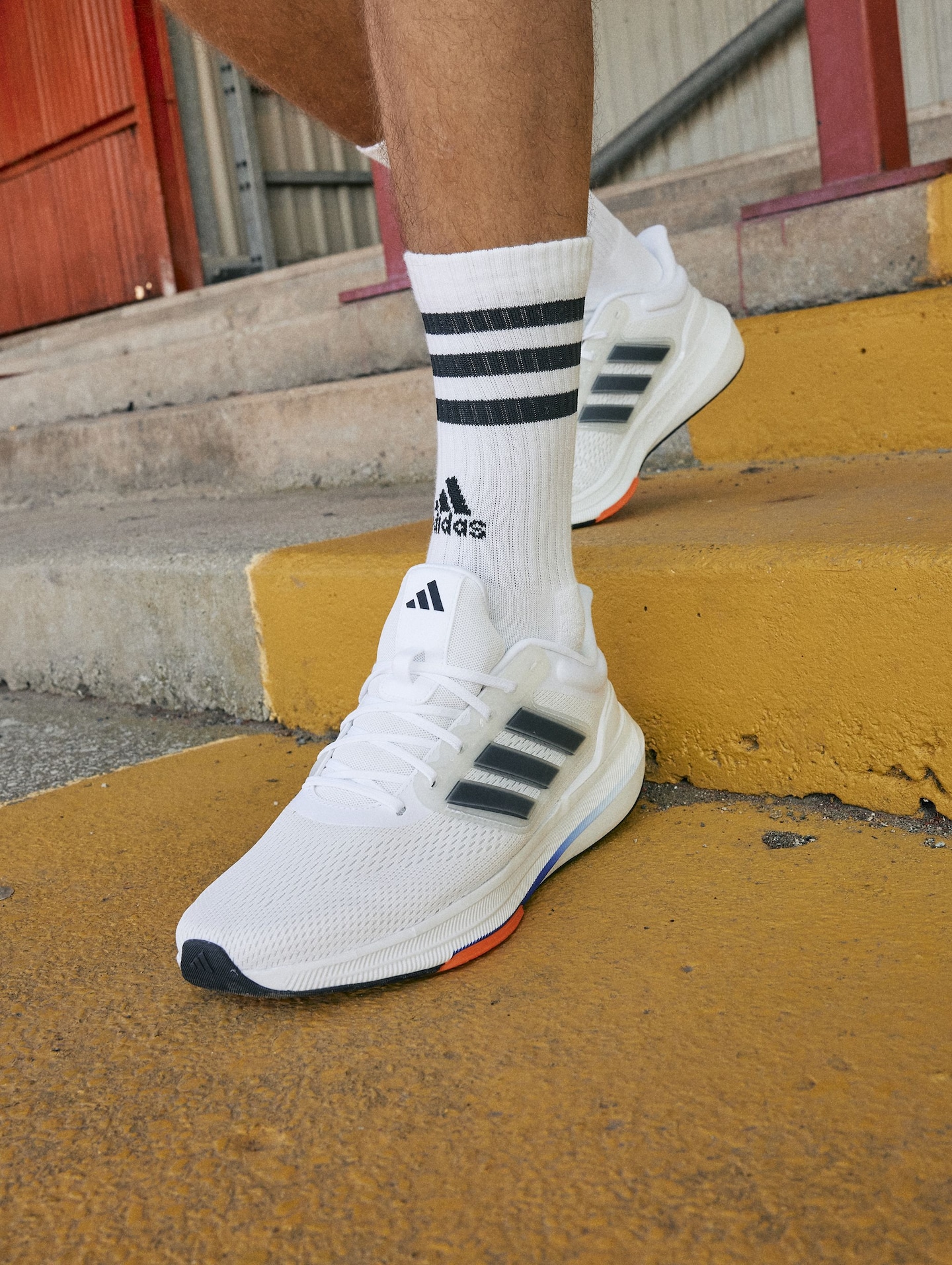 White adidas trainers with white ankle socks and black stripes