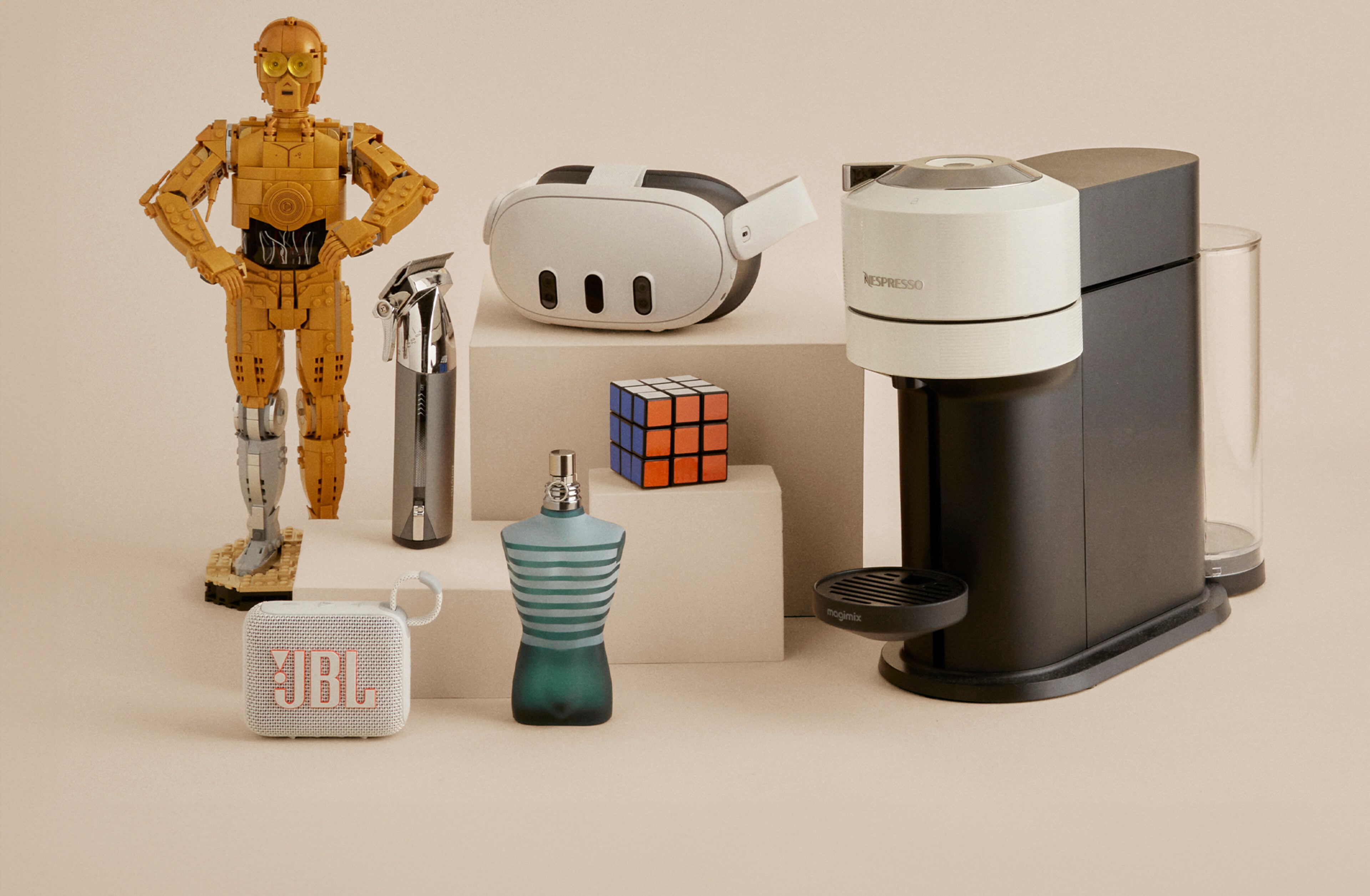 Multiple products including a VR headset, coffee machine and JBL speaker laid out next to each other