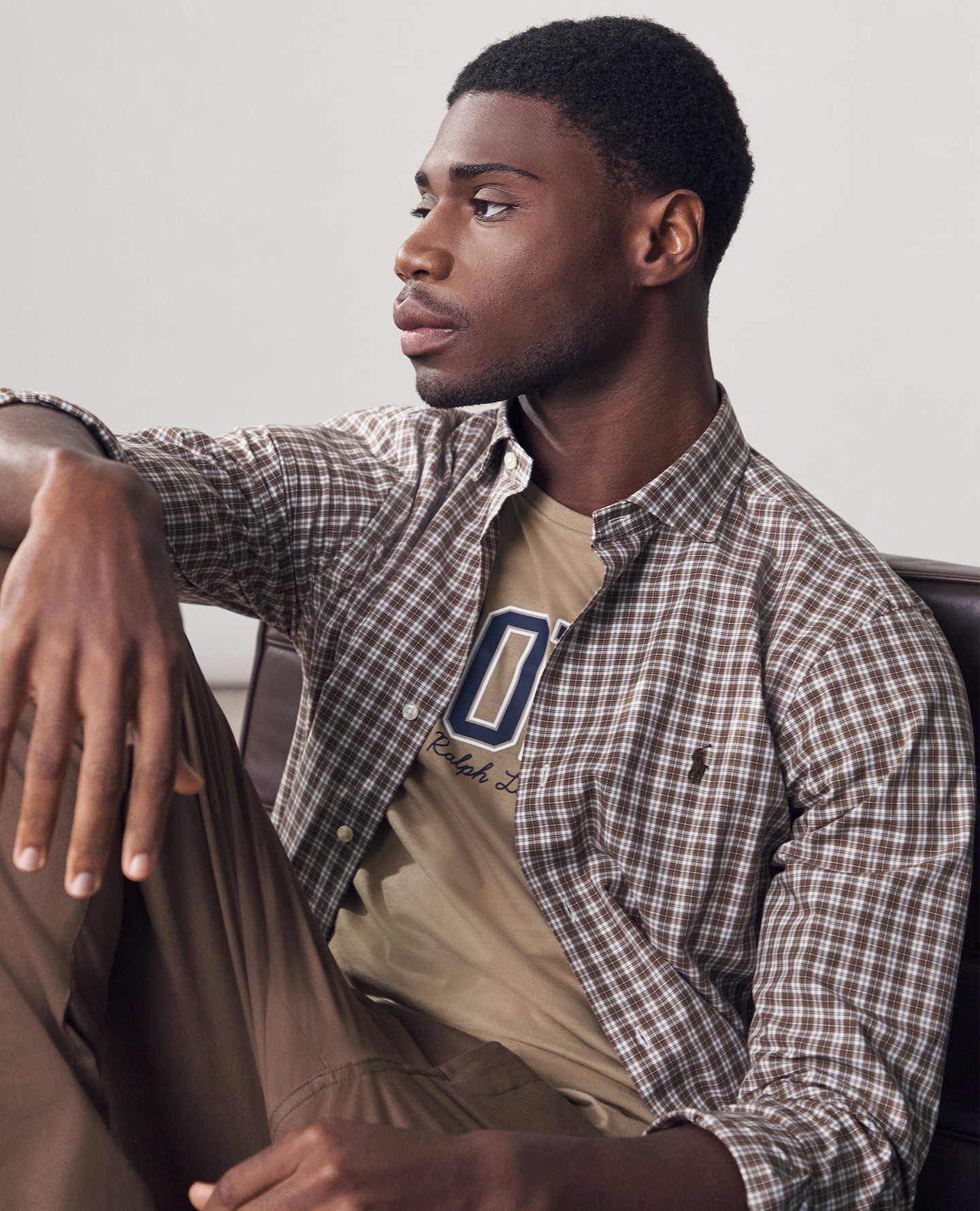 Model wears Polo Ralph Lauren Long Sleeve Stretch Check Poplin Shirt - Brown with Polo Ralph Lauren Short Sleeve Logo T-Shirt - Tan
