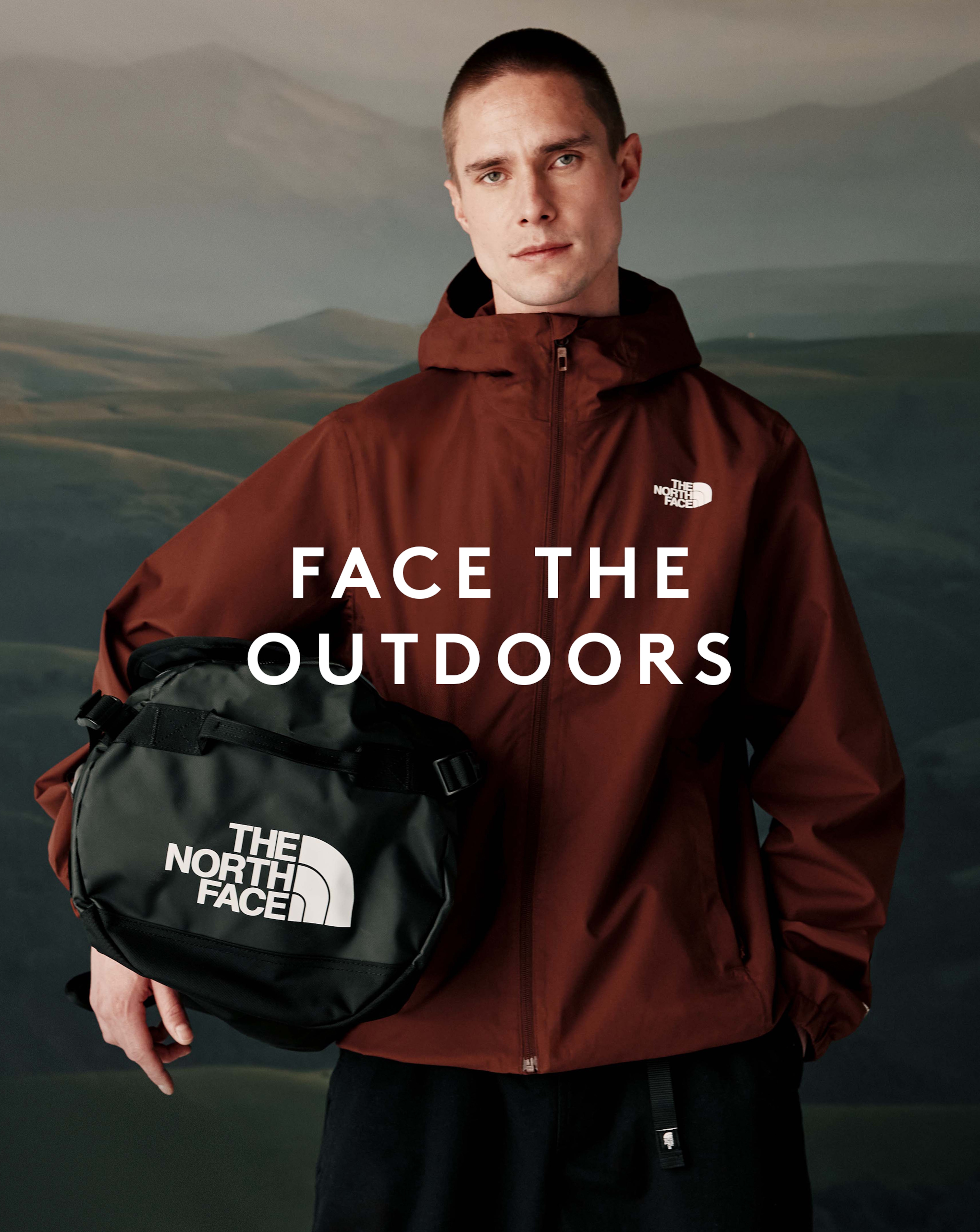 Face the Outdoors. Model wears The North Face Men's DryVent™ Mono Mountain Jacket and holds bag.
