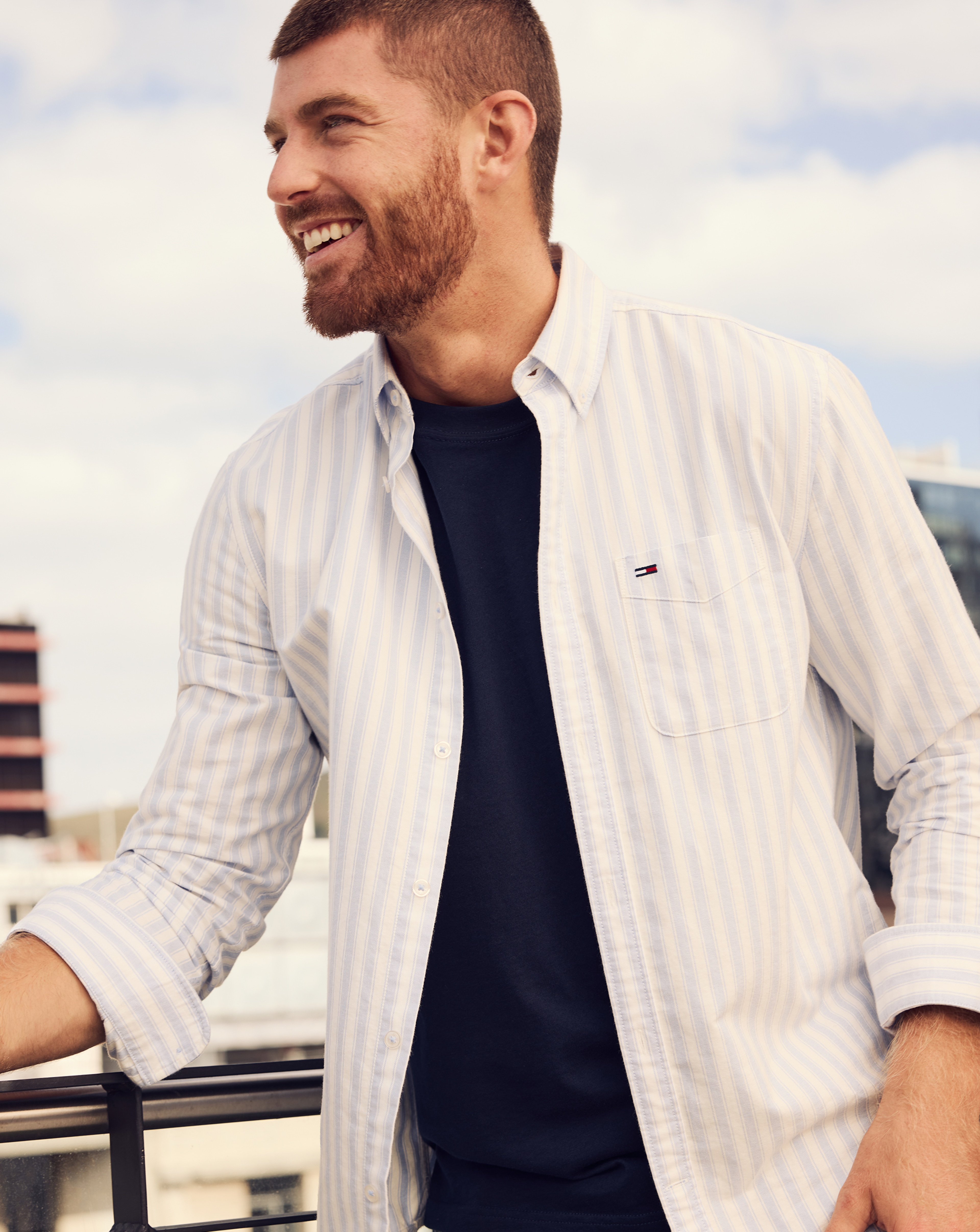 Model wears TTommy Jeans Long Sleeve Regular Stripe Oxford Shirt - Blue