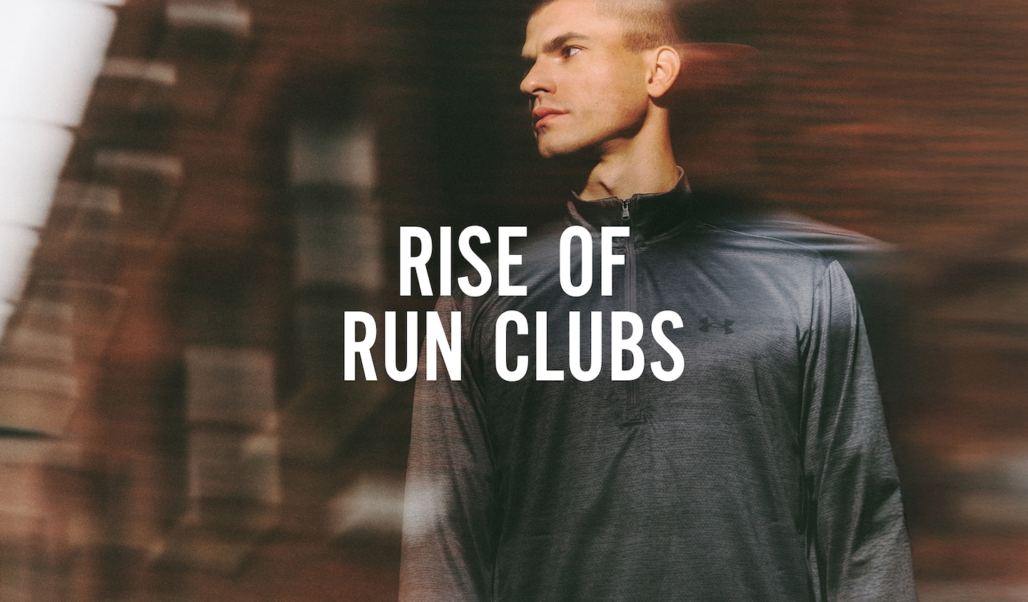 Rise Of Run Clubs. Runner is pictured against town building wears Under Armour