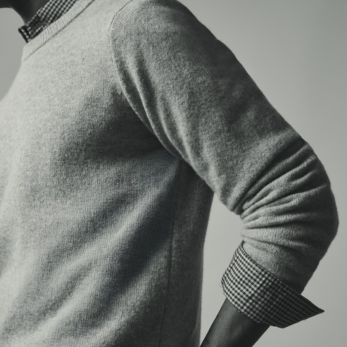 Model wears Lambswool Crew Neck Knitted Jumper with striped shirt