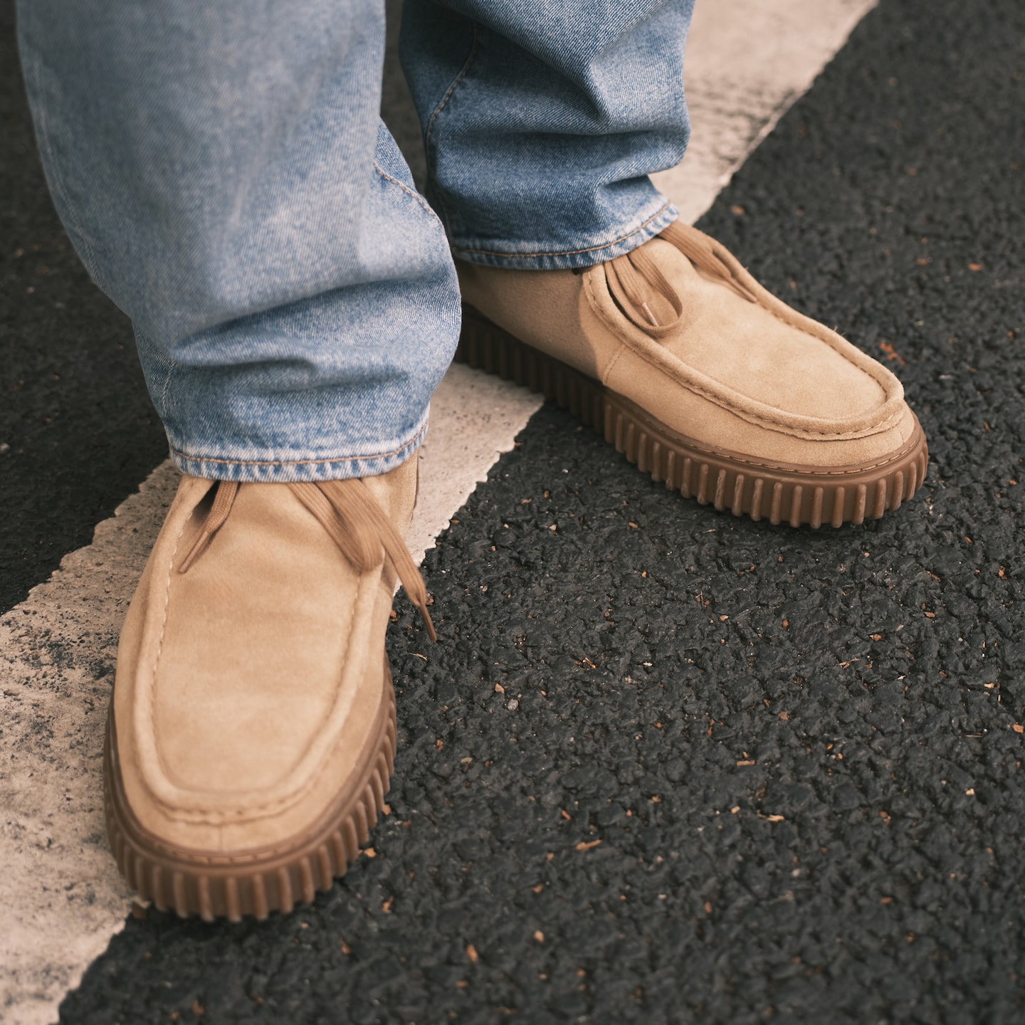 Model wears cream loafer style shoes