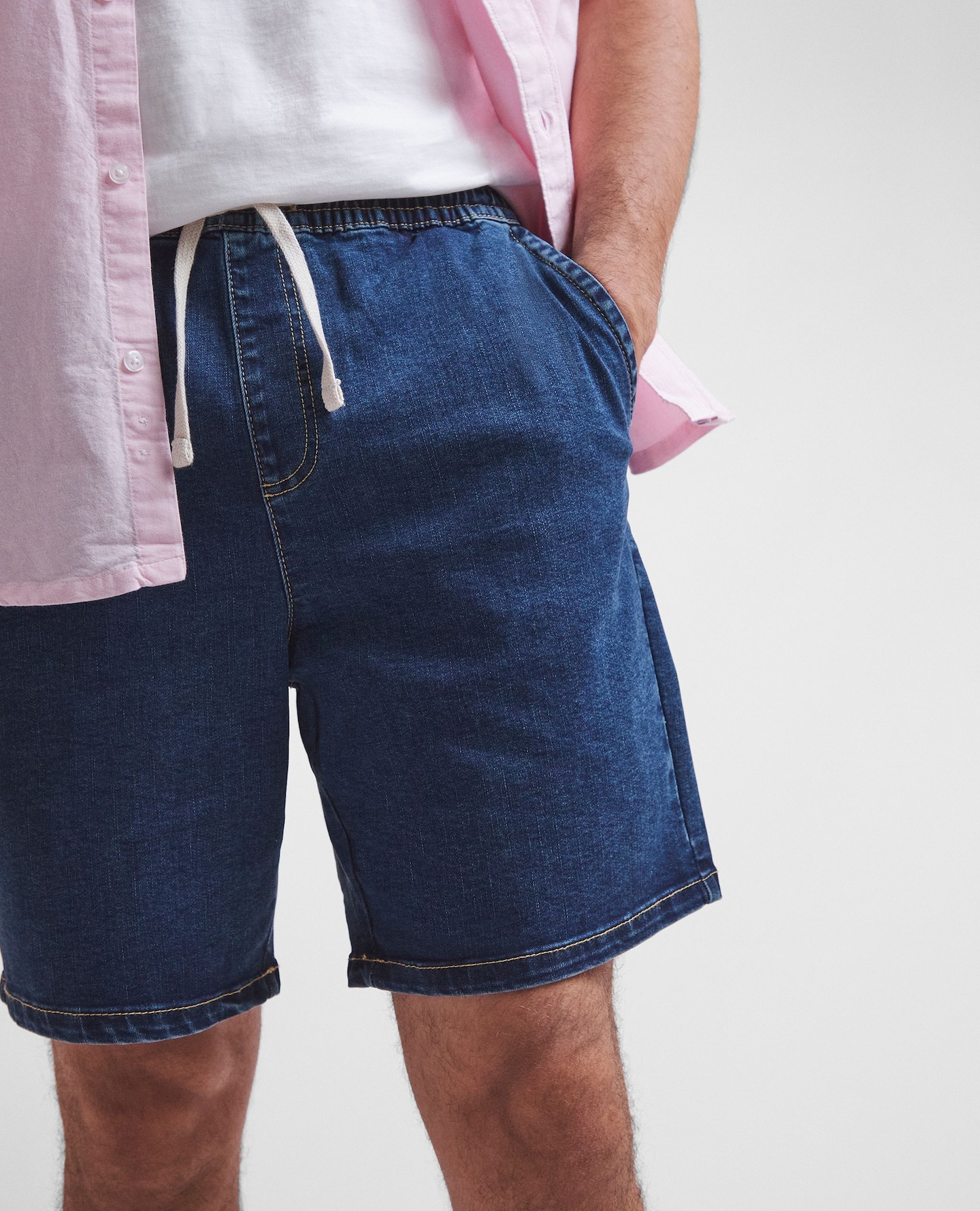 Model wears denim shorts