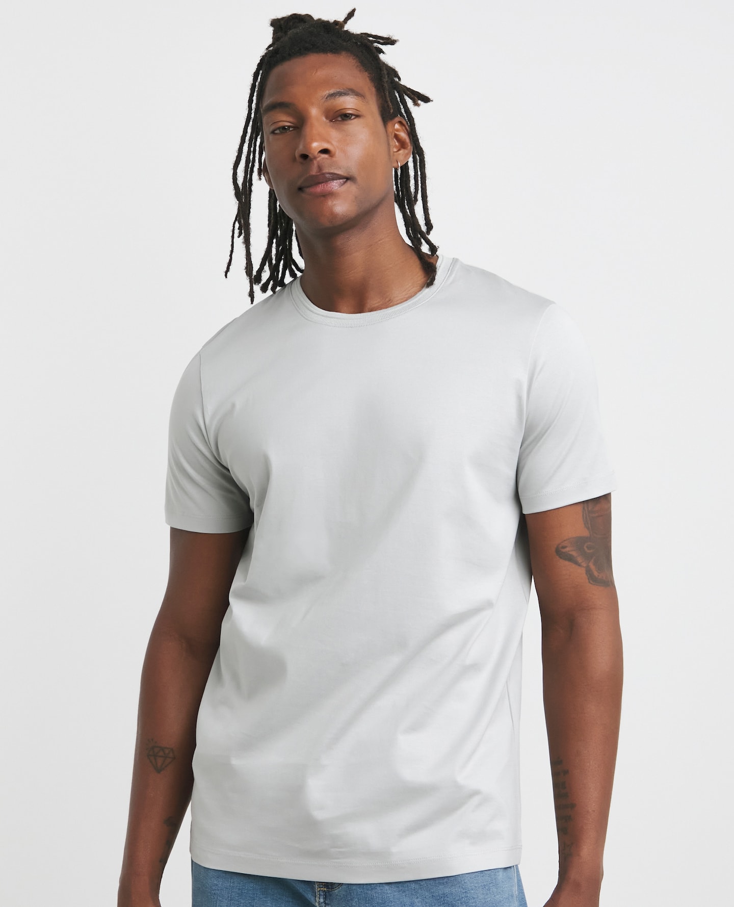 Model wearing a long length grey t-shirt