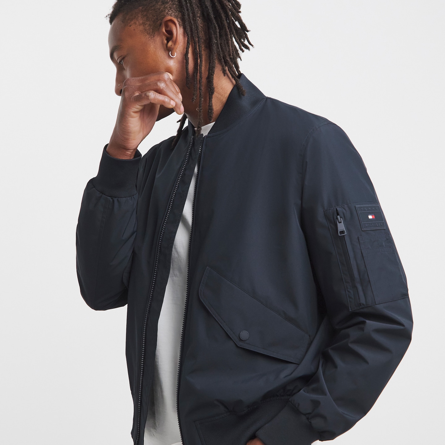 Model wearing a black Tommy Hilfiger jacket