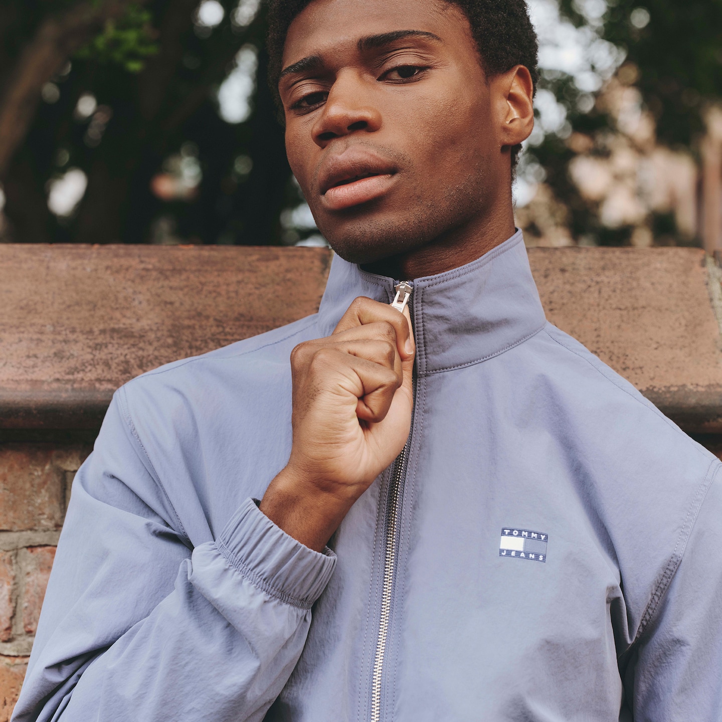 Model wears Tommy Jeans Essential Lightweight Jacket - Blue