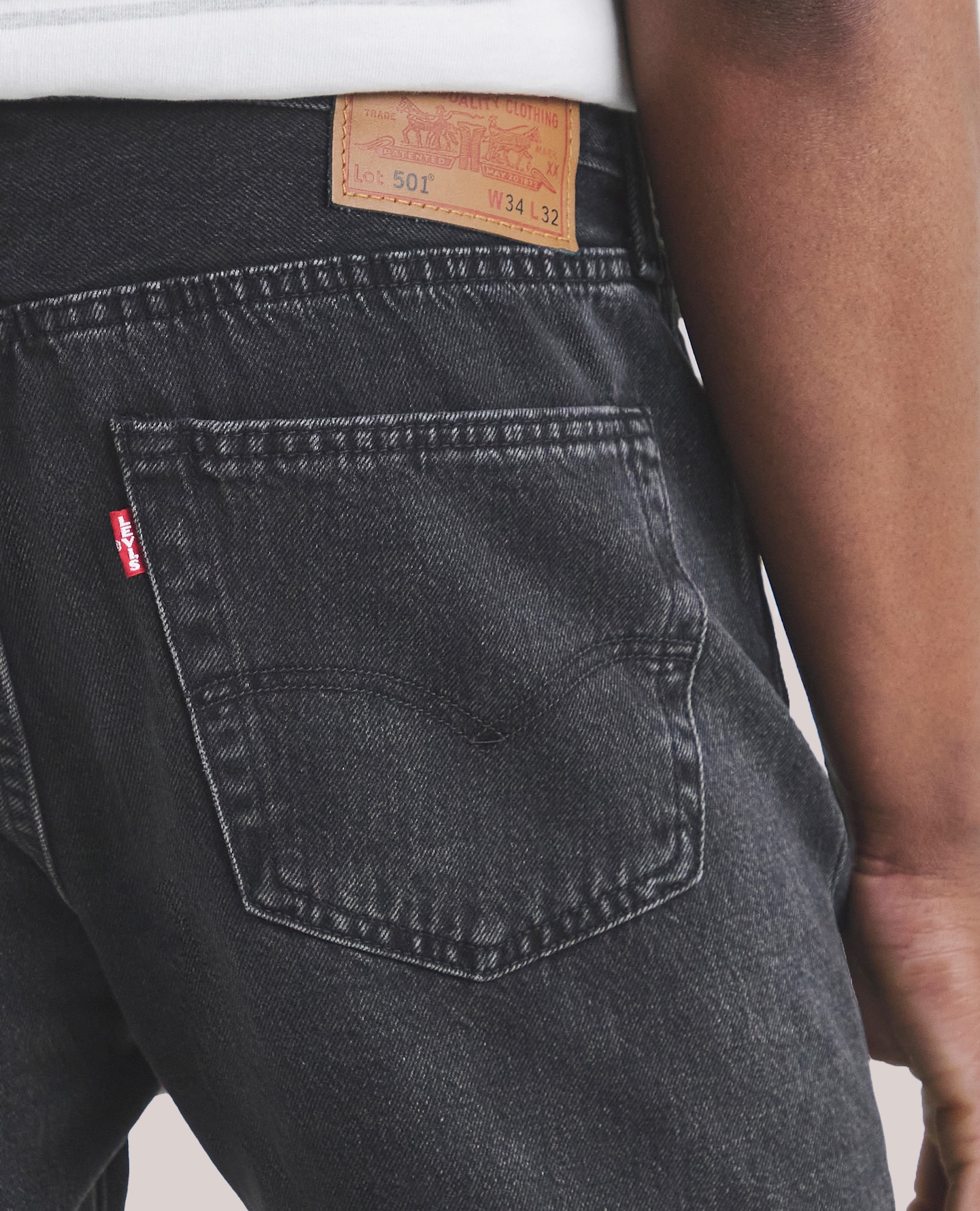 Model wearing black Levi's jeans
