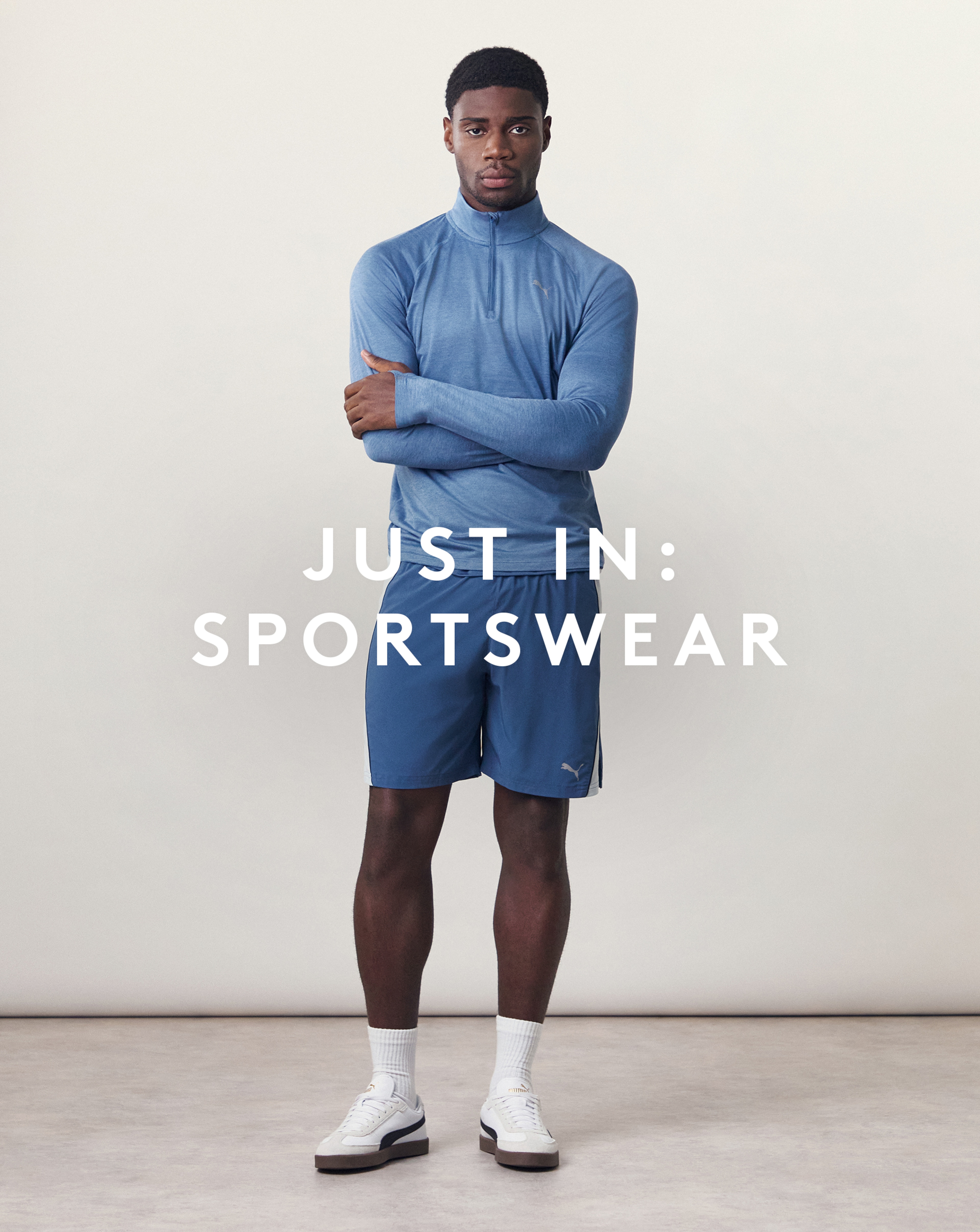 Just In: Sportswear. Model wears PUMA Run Velocity Cloudspun 1/4 Zip with Puma Blue Sports Shorts