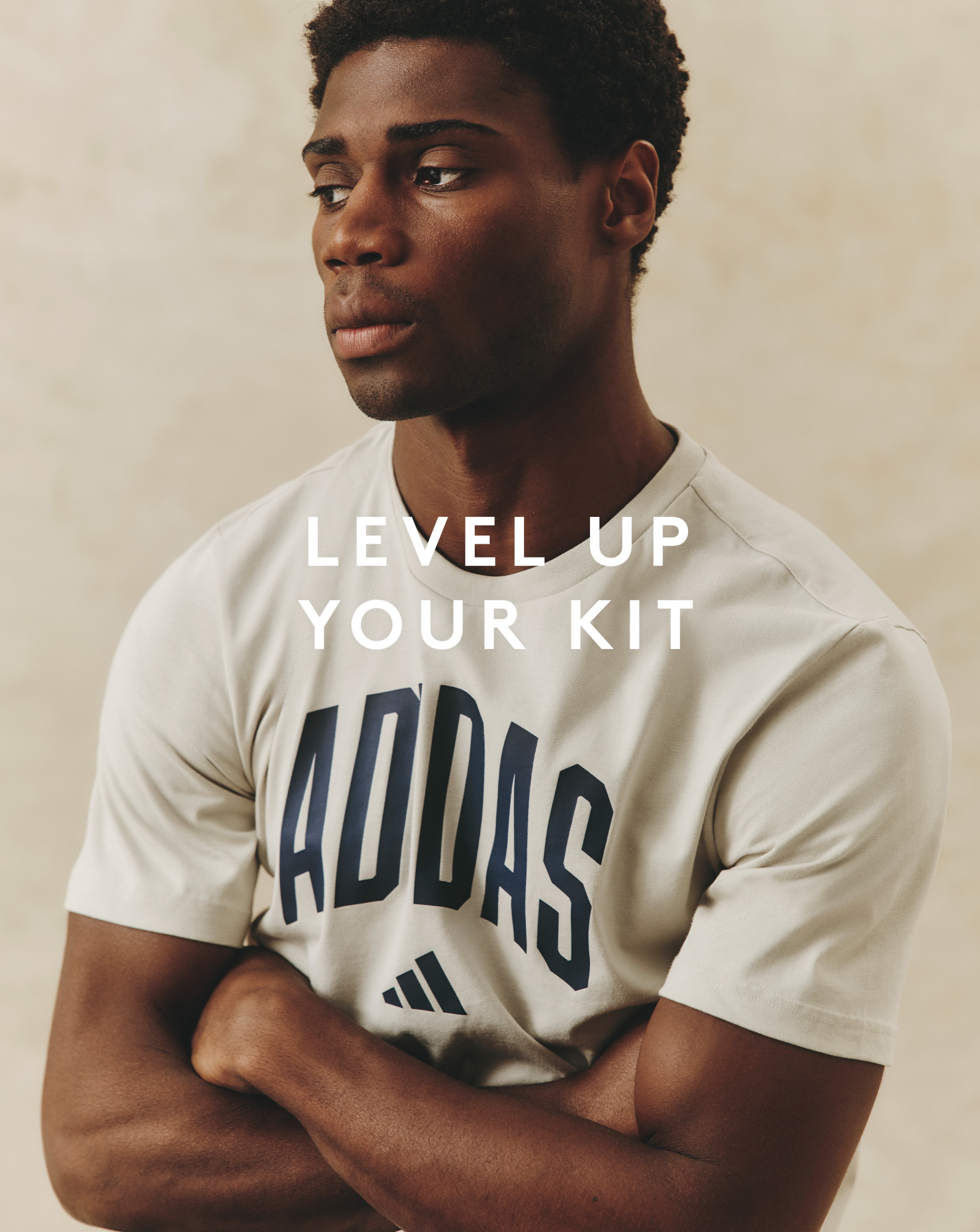 Model wearing white adidas logo t-shirt 