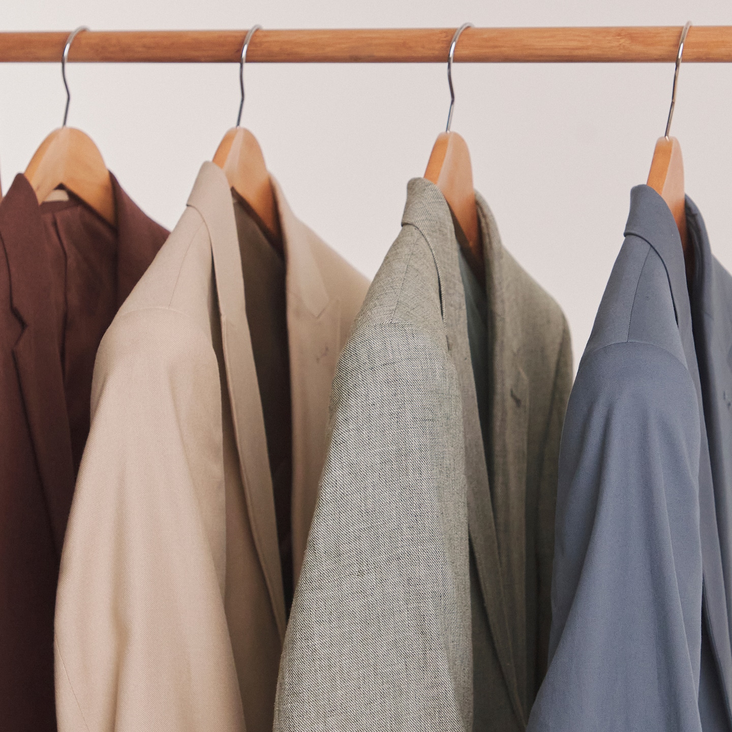 Formalwear - Blazers displayed on rail, various styles.