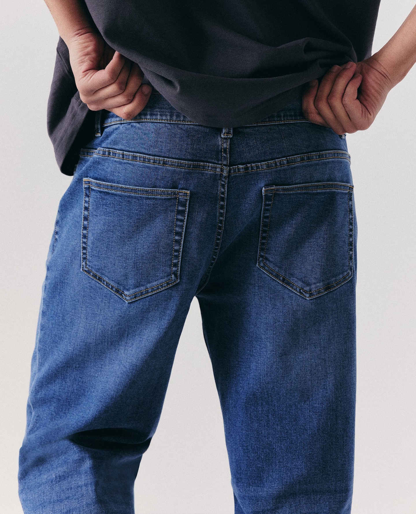 Model wears loose fit jeans