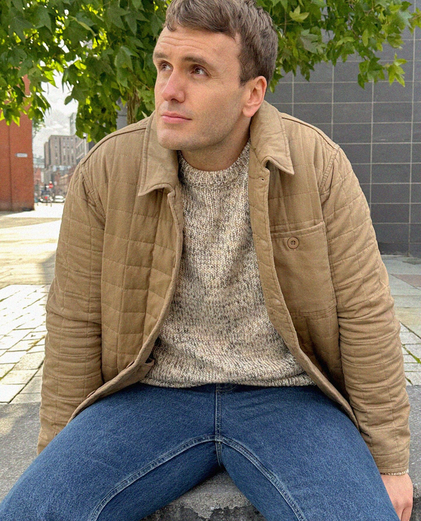 Ben James pictured wears Tan Cotton Quilted Shacket with cream jumper and blue jeans
