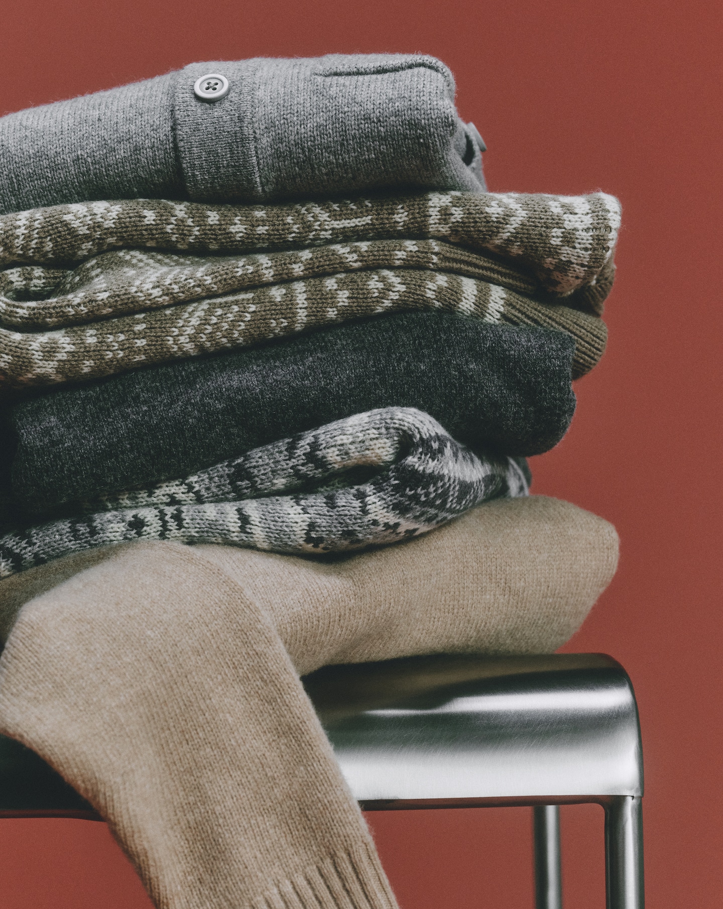 Knitwear displayed on a chrome chair