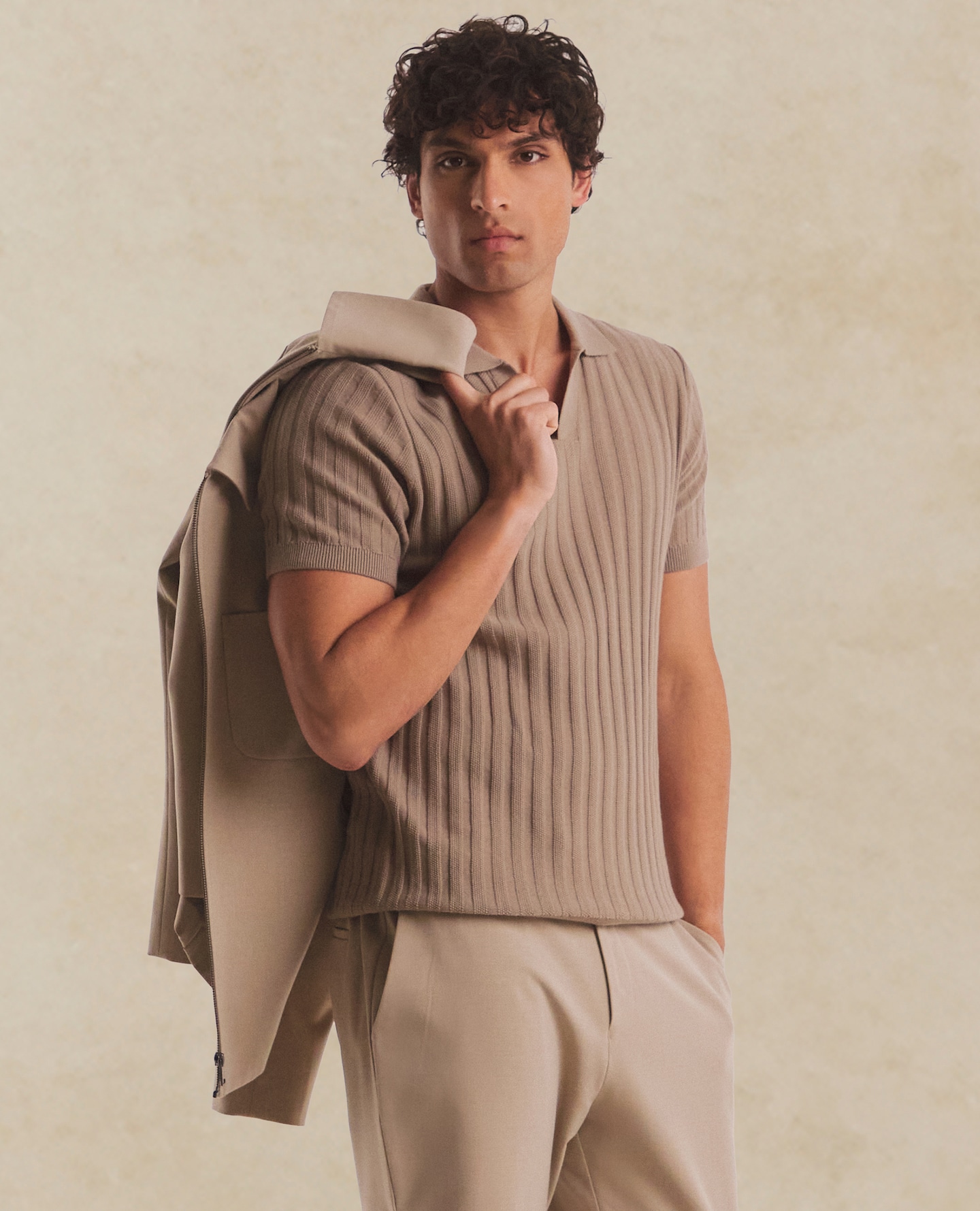 Model wears Textured Trophy Neck Tipped Knit Polo with Tailored Tapered Trouser and Jacket in Cream