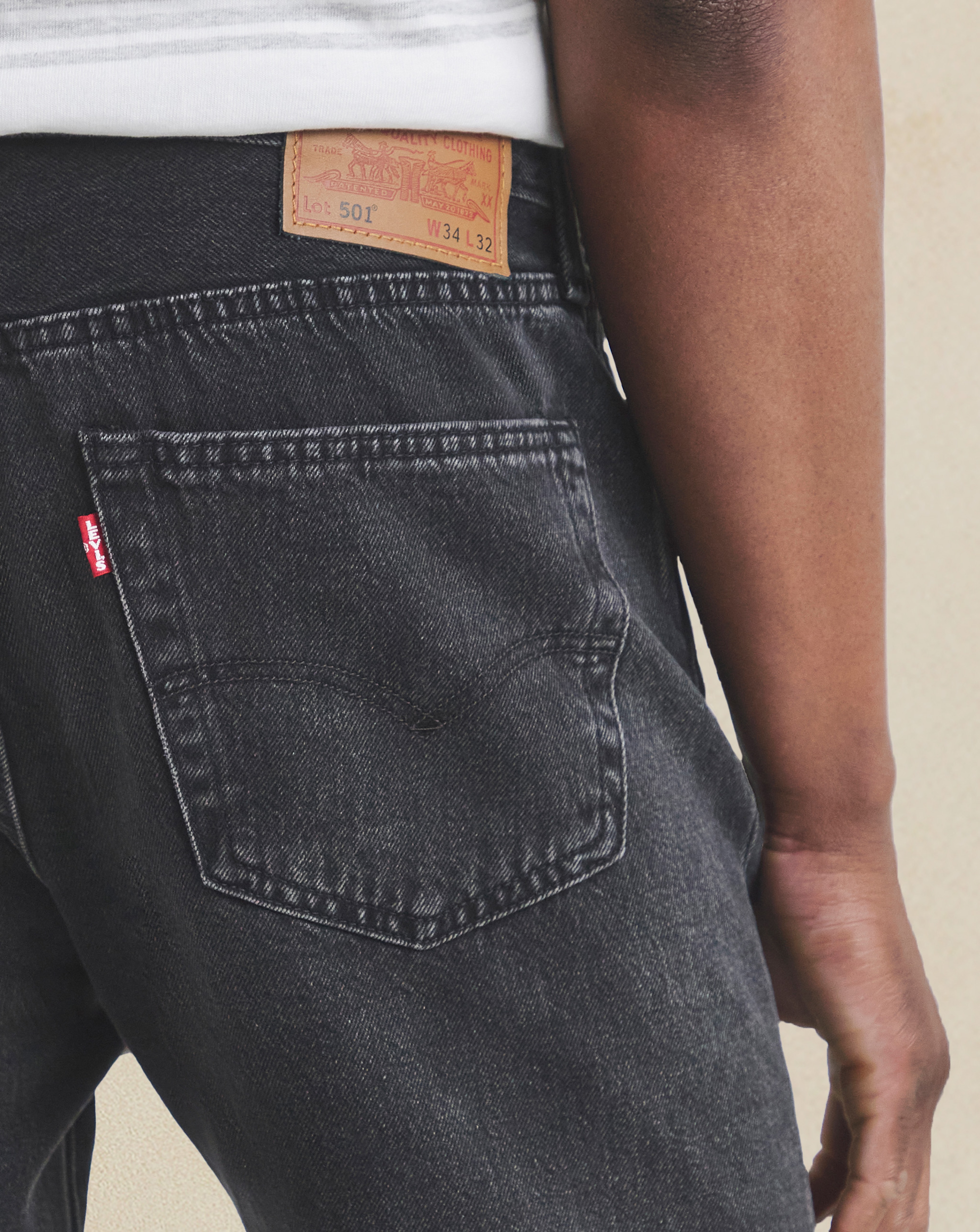 Model wearing black Levi's jeans