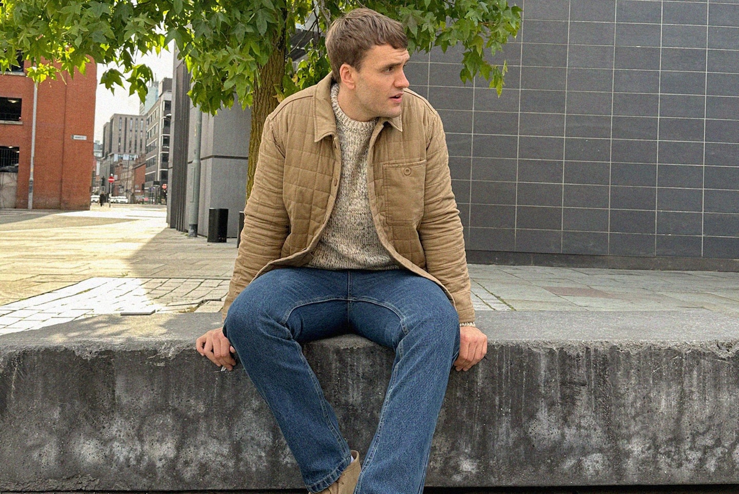 Ben James pictured wears Tan Cotton Quilted Shacket with cream jumper and blue jeans