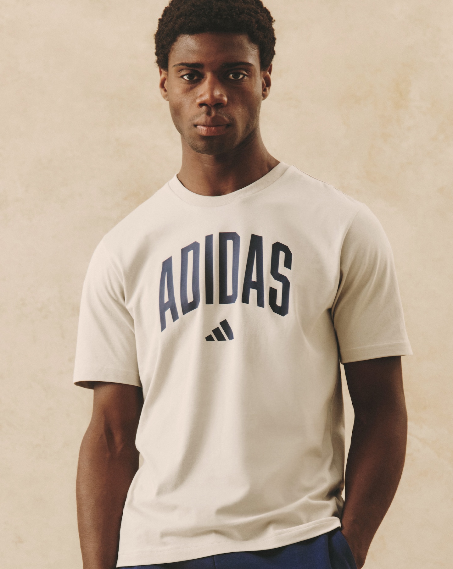 Model wearing white adidas t-shirt