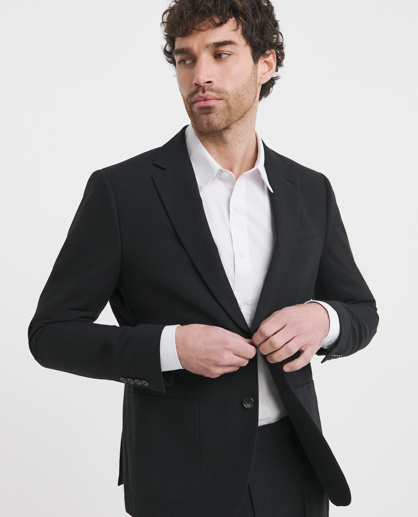 Model wearing black blazer and white shirt