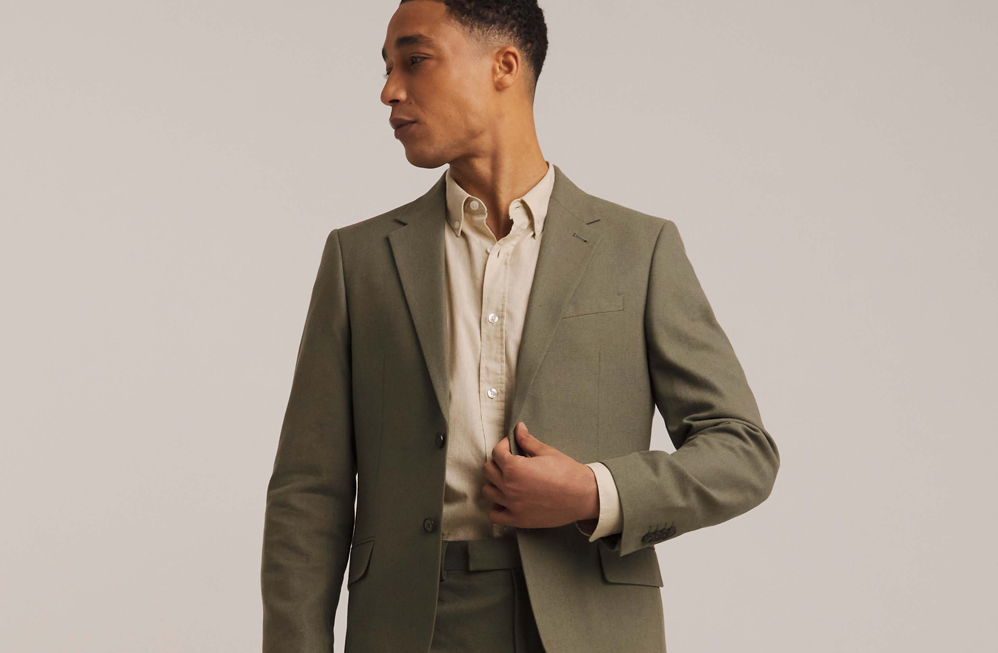 Model wears Linen Blend Blazer in green with beige formal shirt