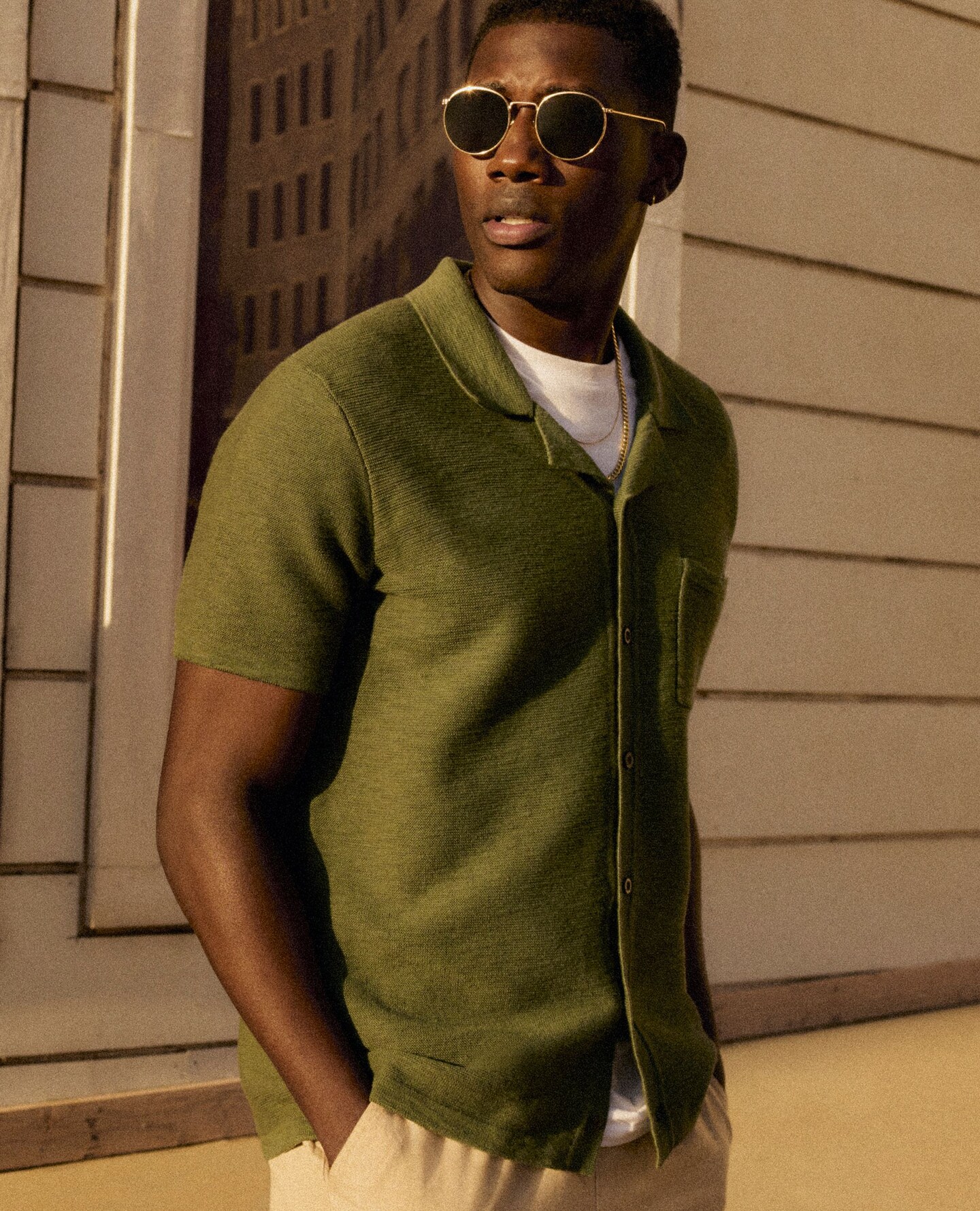 Model wears green collar shirt