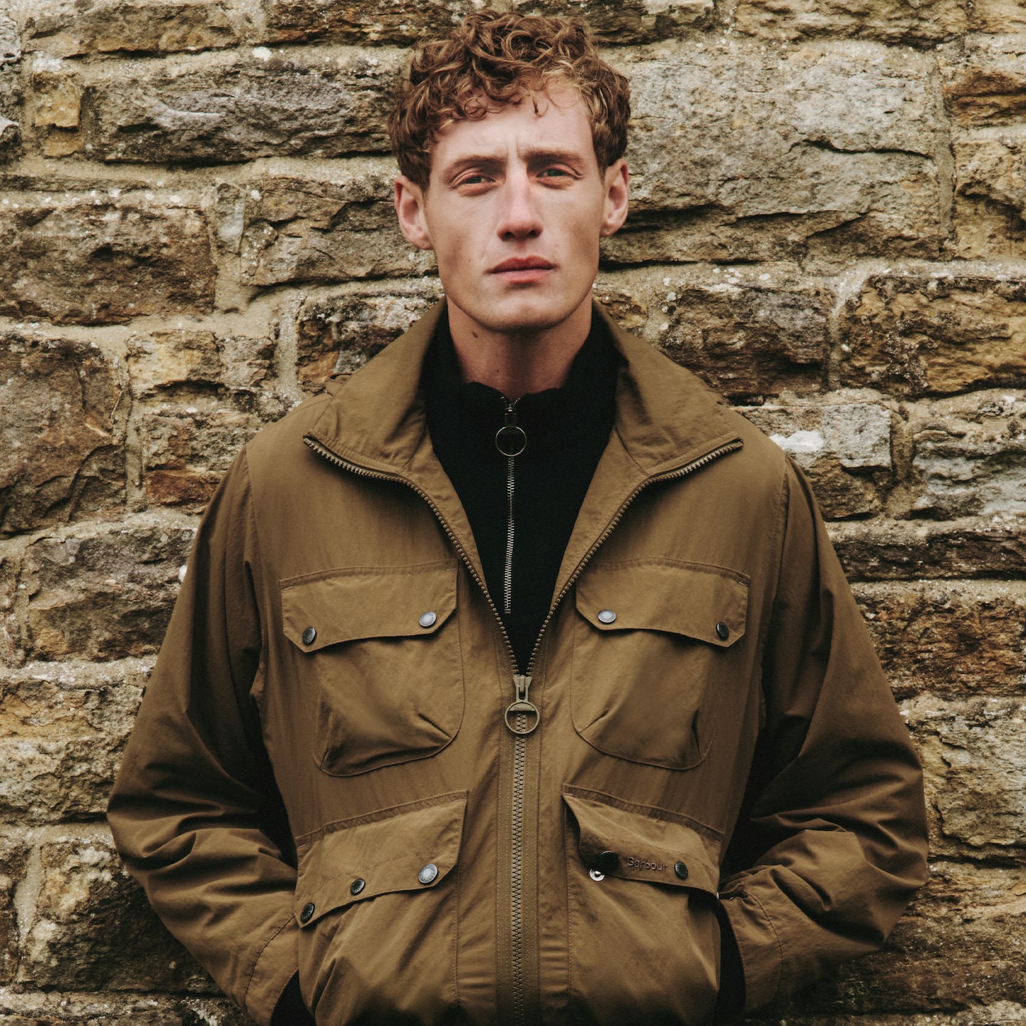Model wearing khaki Barbour coat