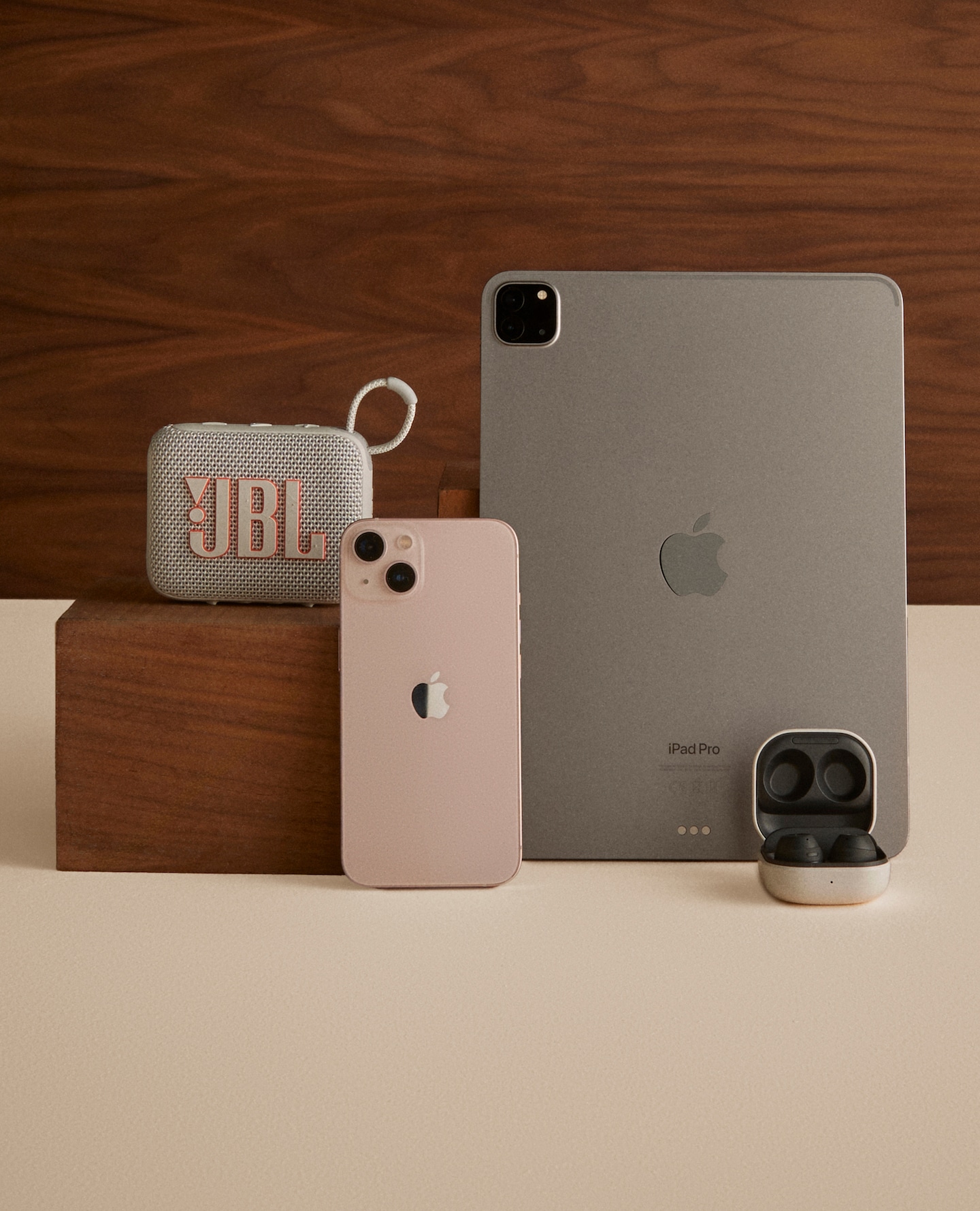 Tech pictured including iPad, iPhone, earbuds and JBL speaker