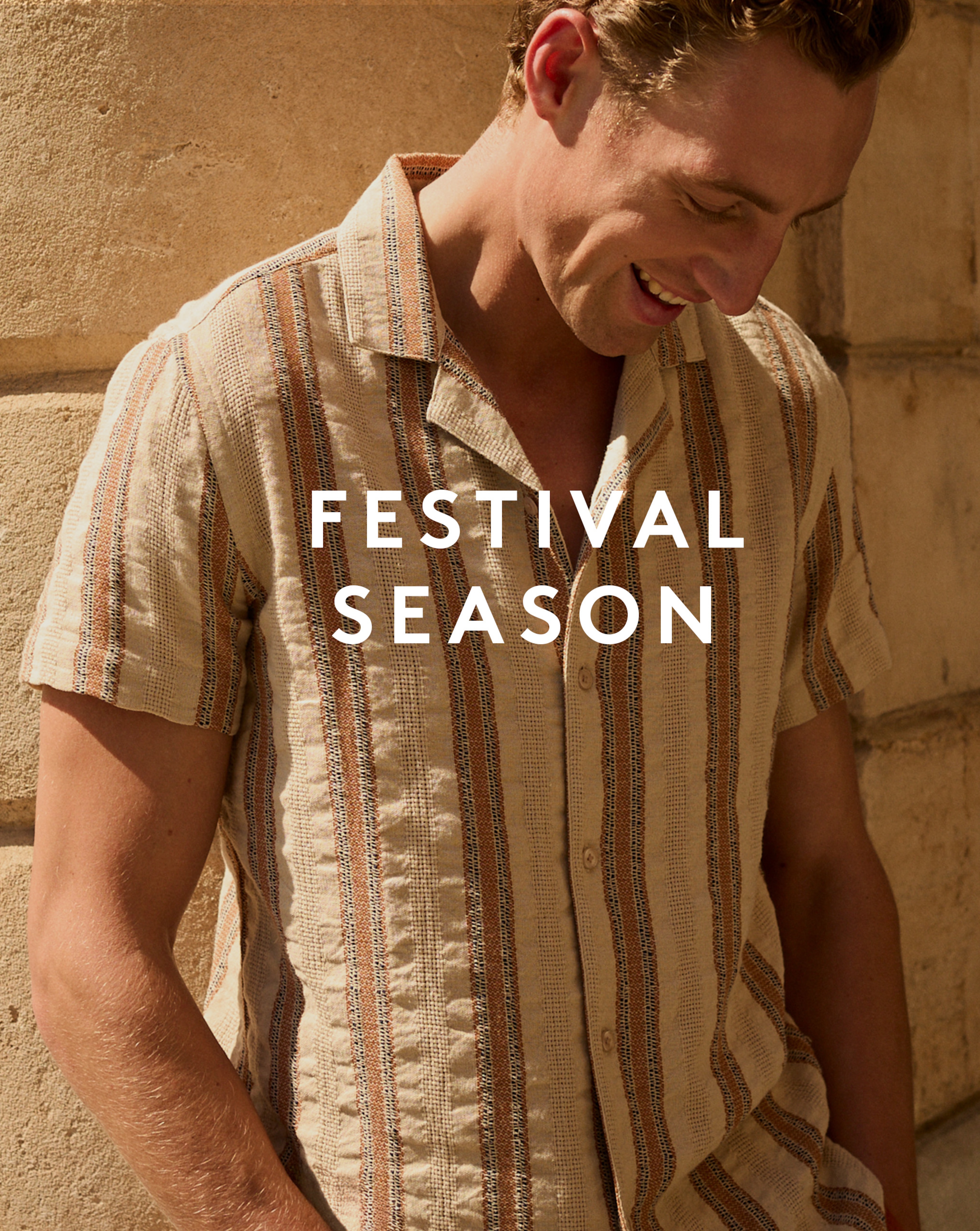 Model wearing multi-coloured striped shirt