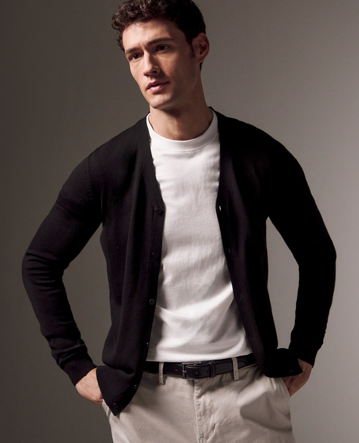 Model wears Value Knitted Cardigan in Black with white tee 