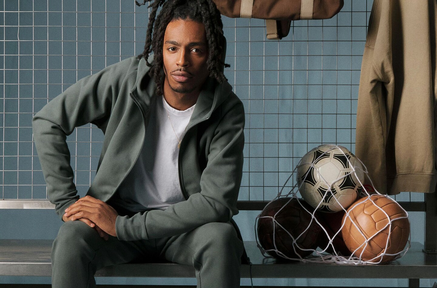 Model wears sports clothes sat in gym room