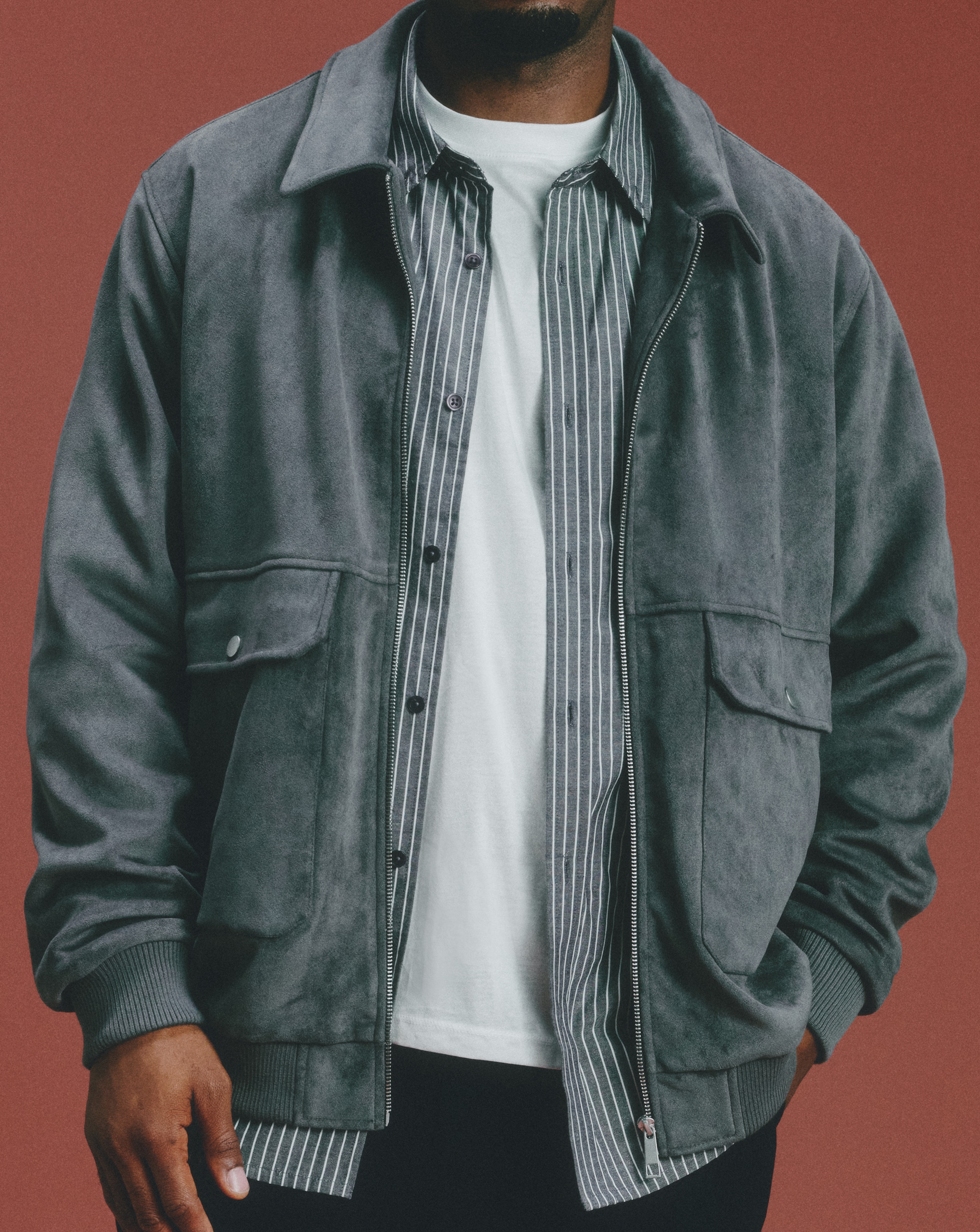 Model wearing a white t-shirt with a striped shirt and denim jacket layered on top