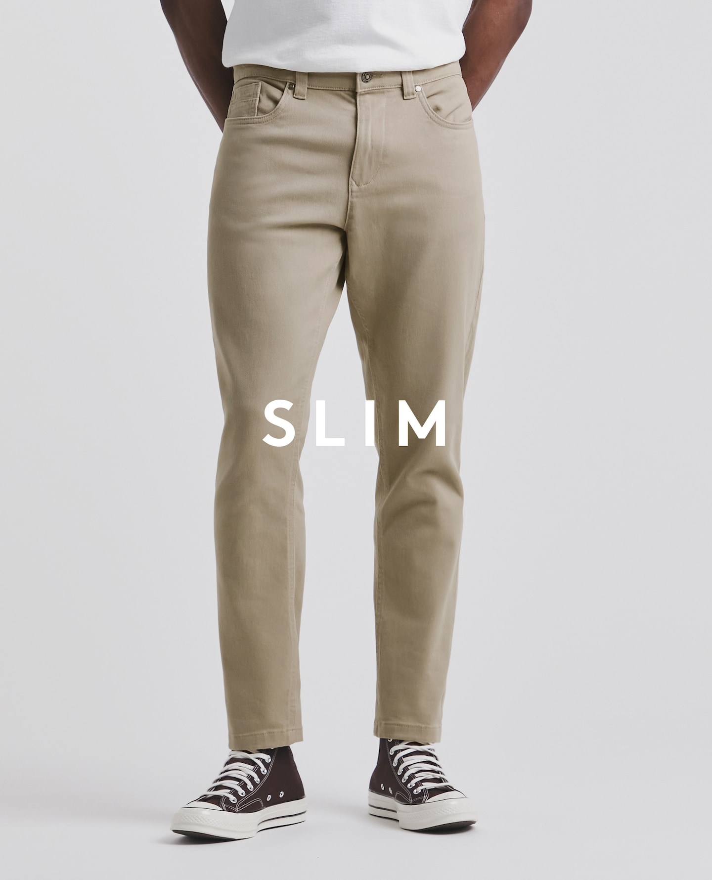 Model wearing slim beige jeans