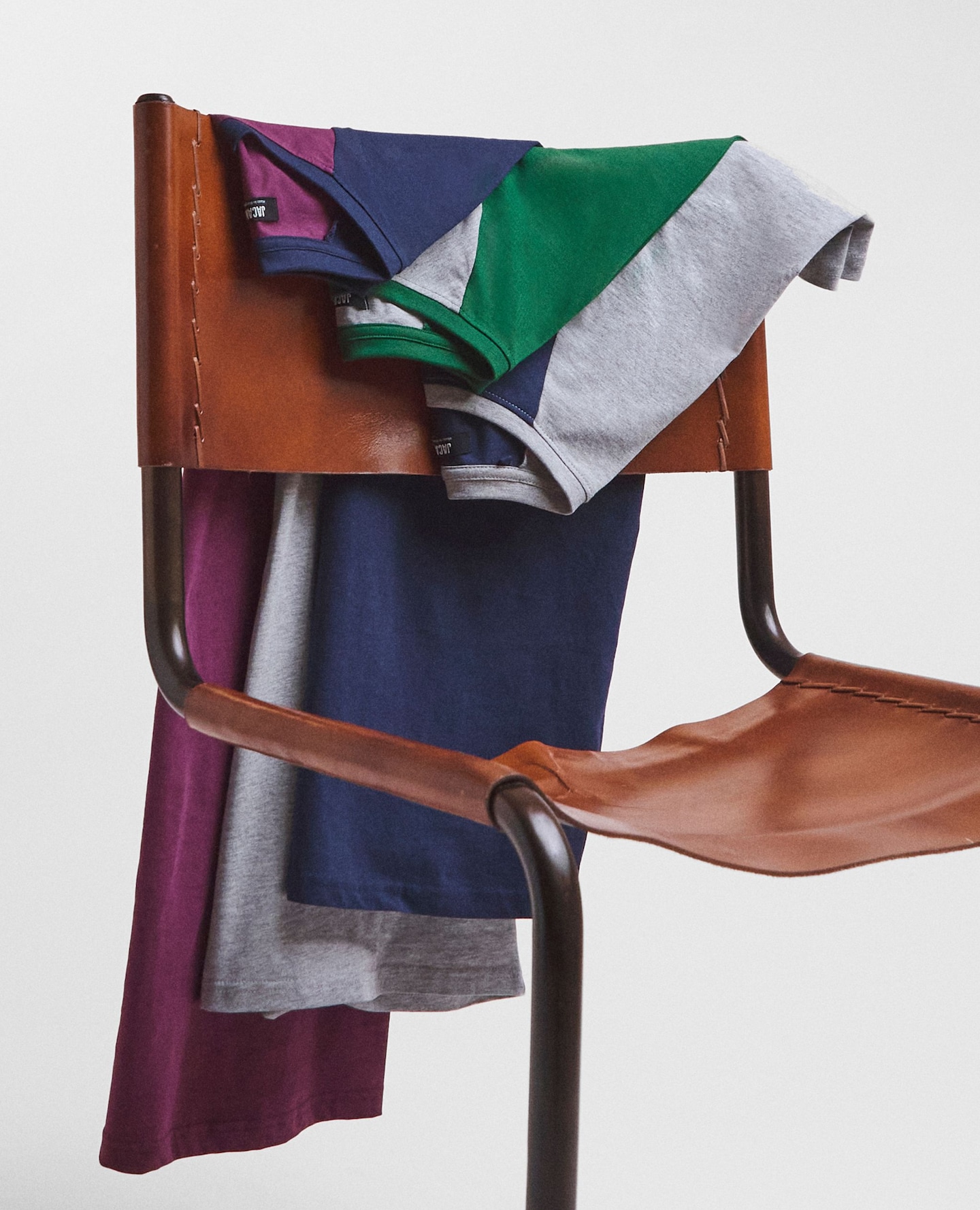 Multipack t-shirts various colours draped over chair