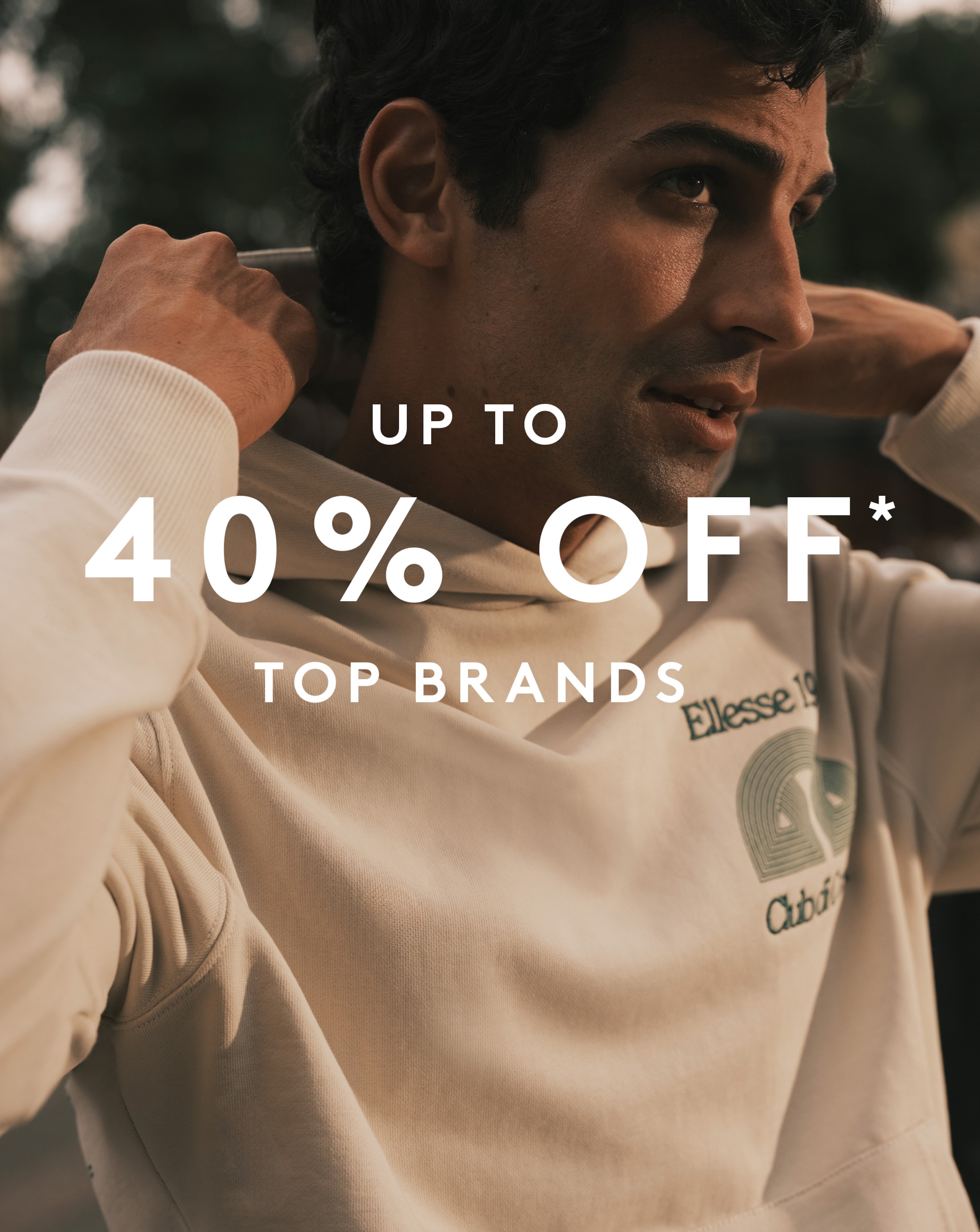 Model wearing a beige Ellesse hoodie