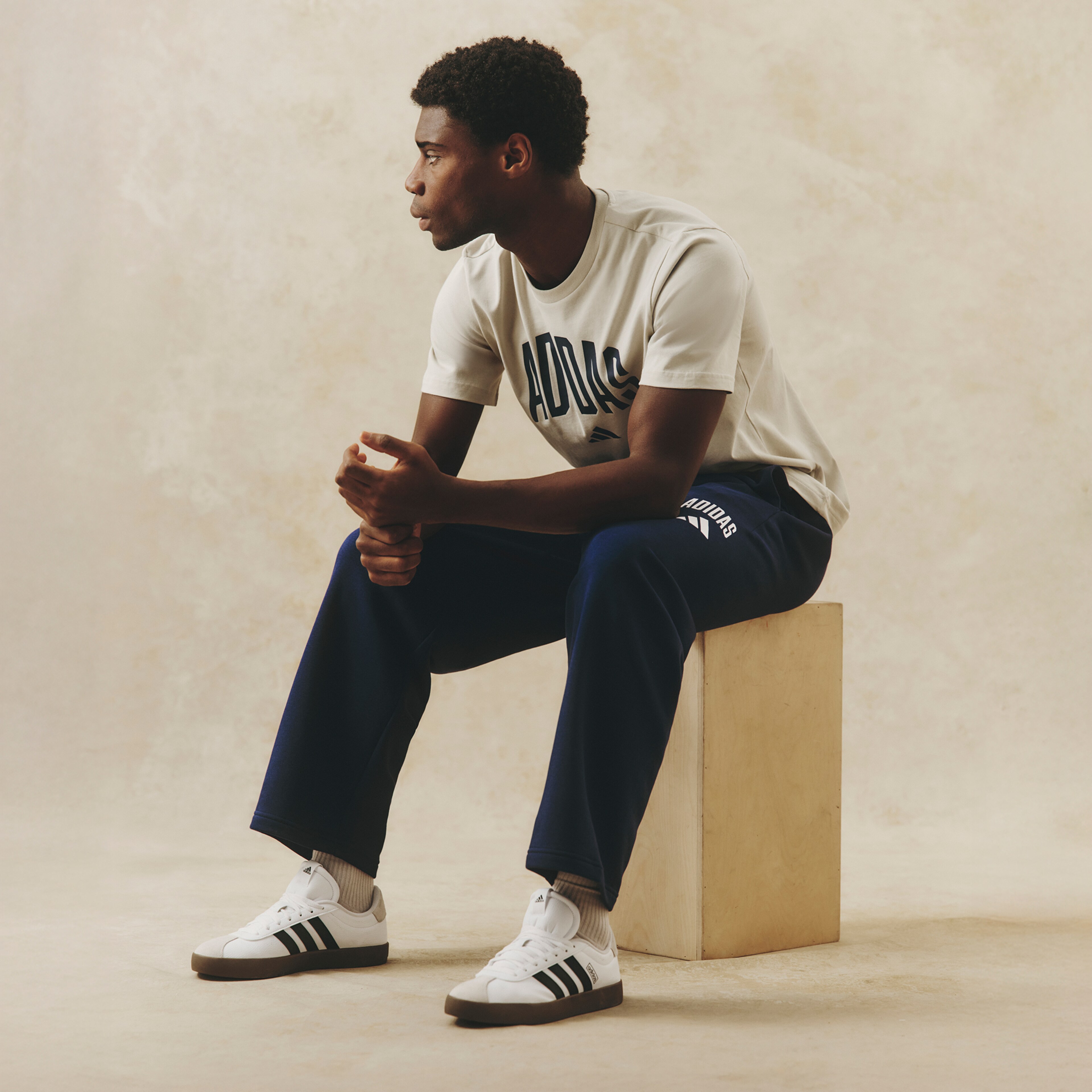 Model wears adidas Collegiate Logo Pants with adidas Collegiate Logo T-Shirt and adidas VL Court 3.0 Trainers