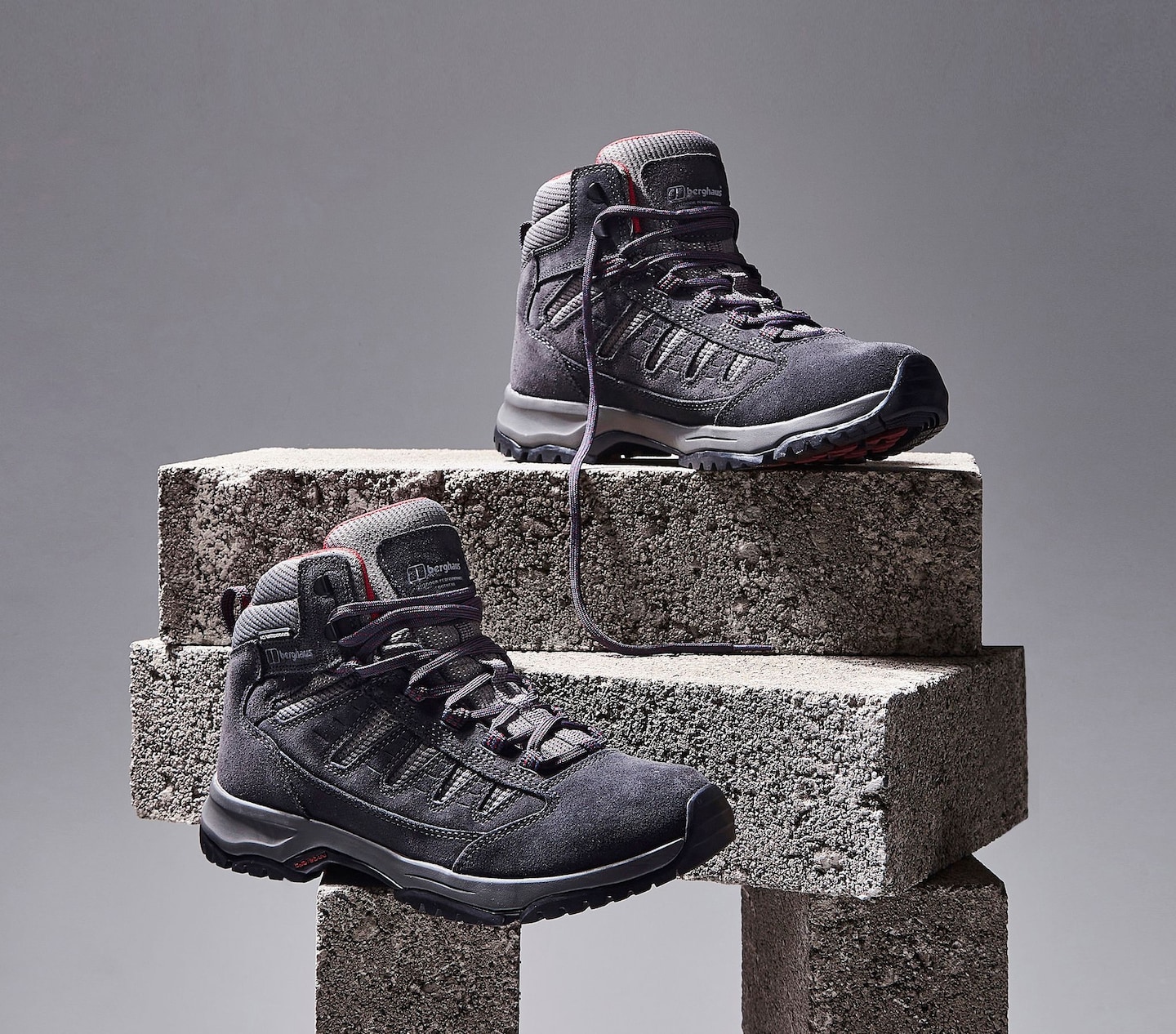 Walking boots stood on some bricks for display