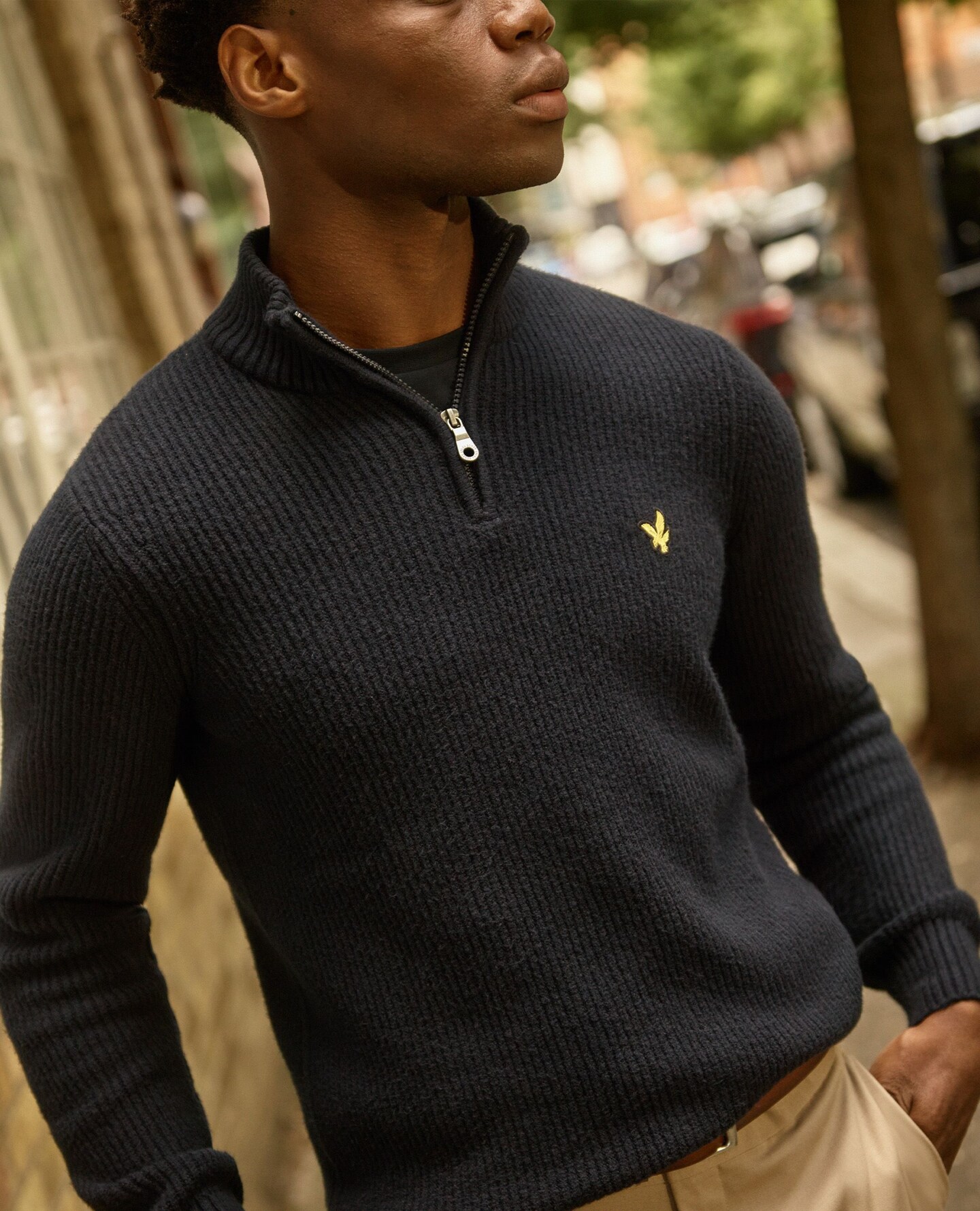 A man wearing a black half zip sweatshirt