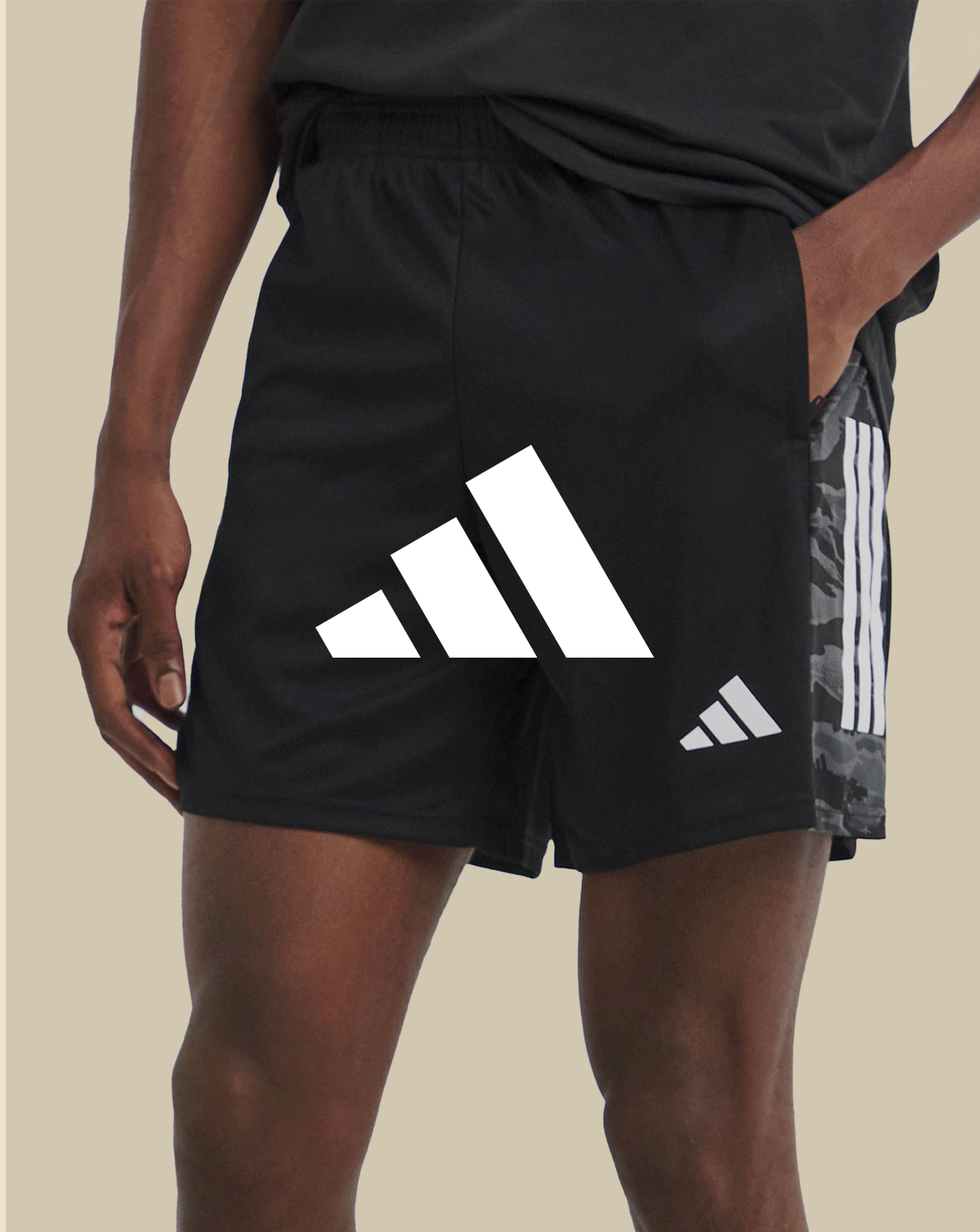 adidas. Model wears adidas Camo 3 Stripes Shorts.