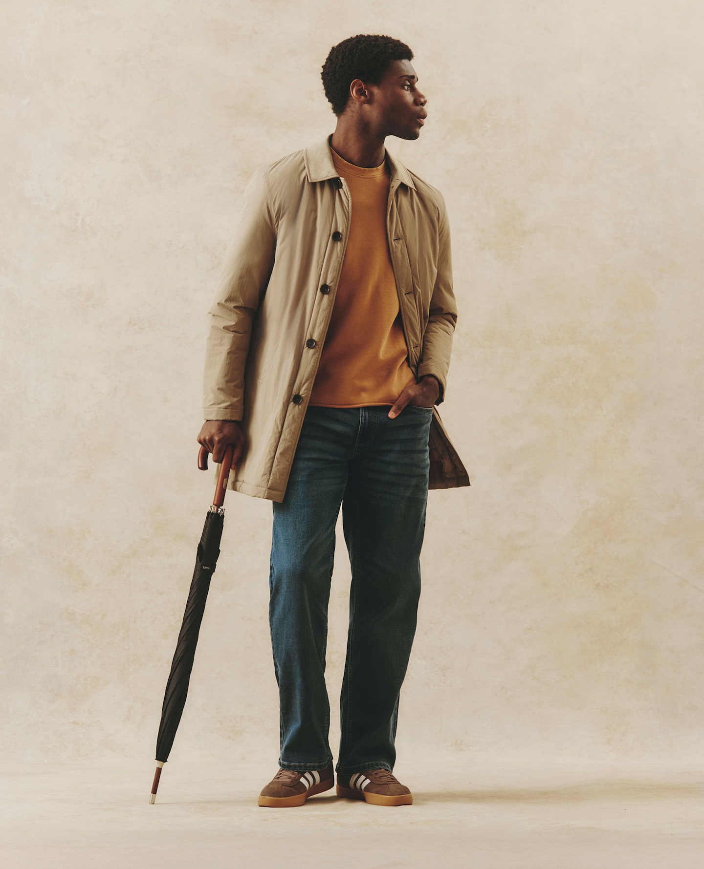 Mode holds umbrella and wears Stone Wadded Mac with casual look