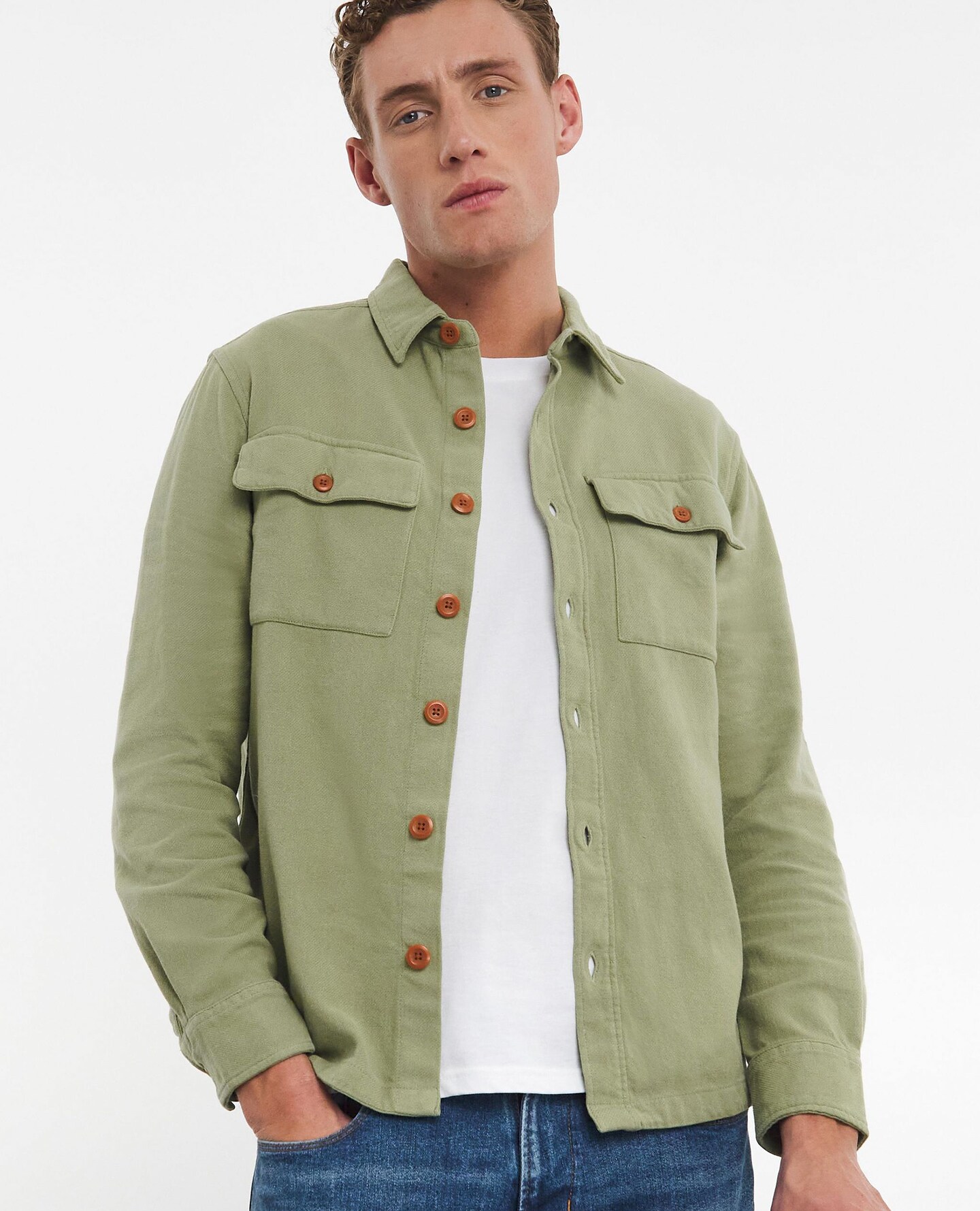Model wearing green shackett, white t-shirt and jeans