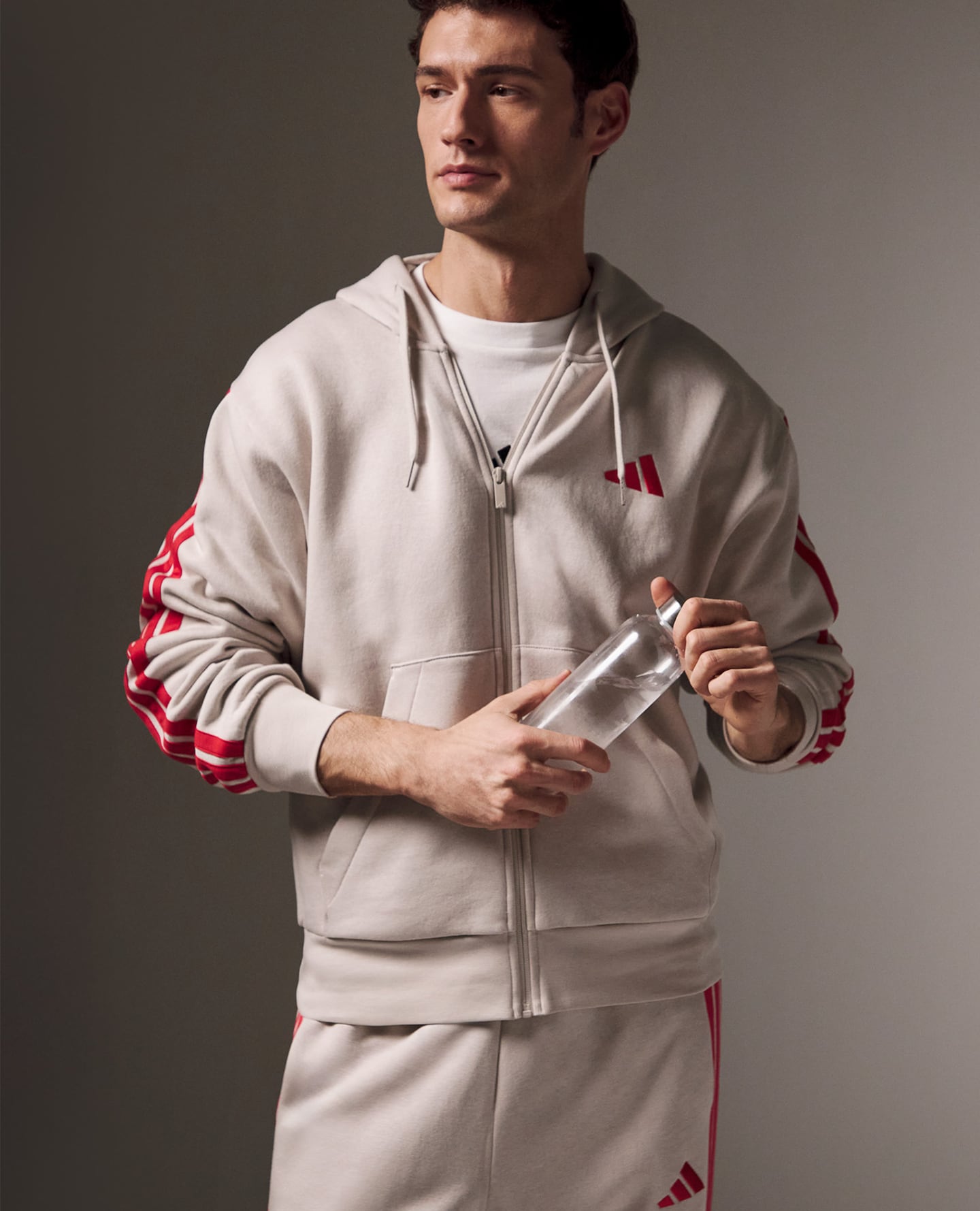 Model wears adidas 3 Stripes Fleece Hoodie and Jog Pants