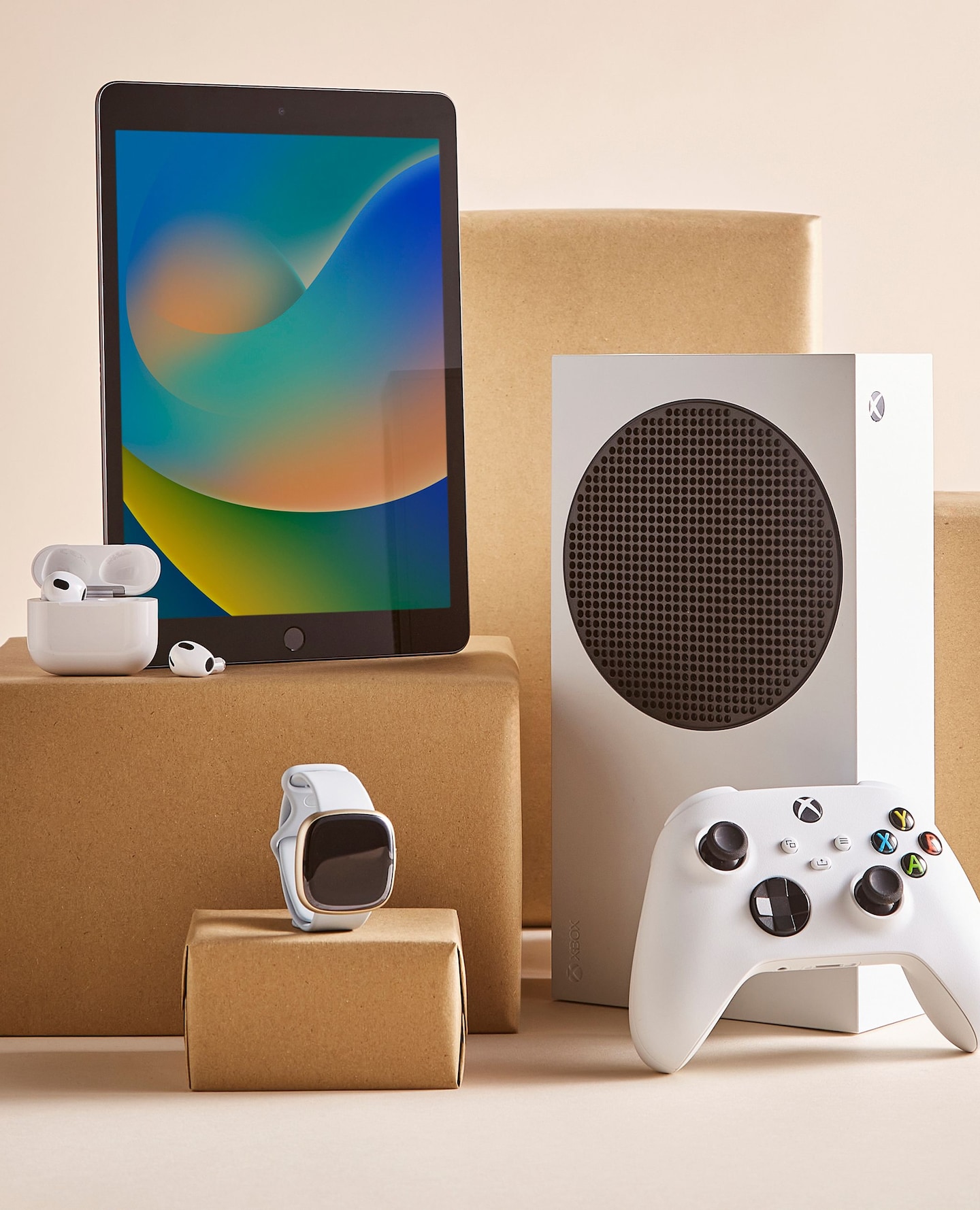 Tech gifts displayed including ear pods, Xbox and iPad