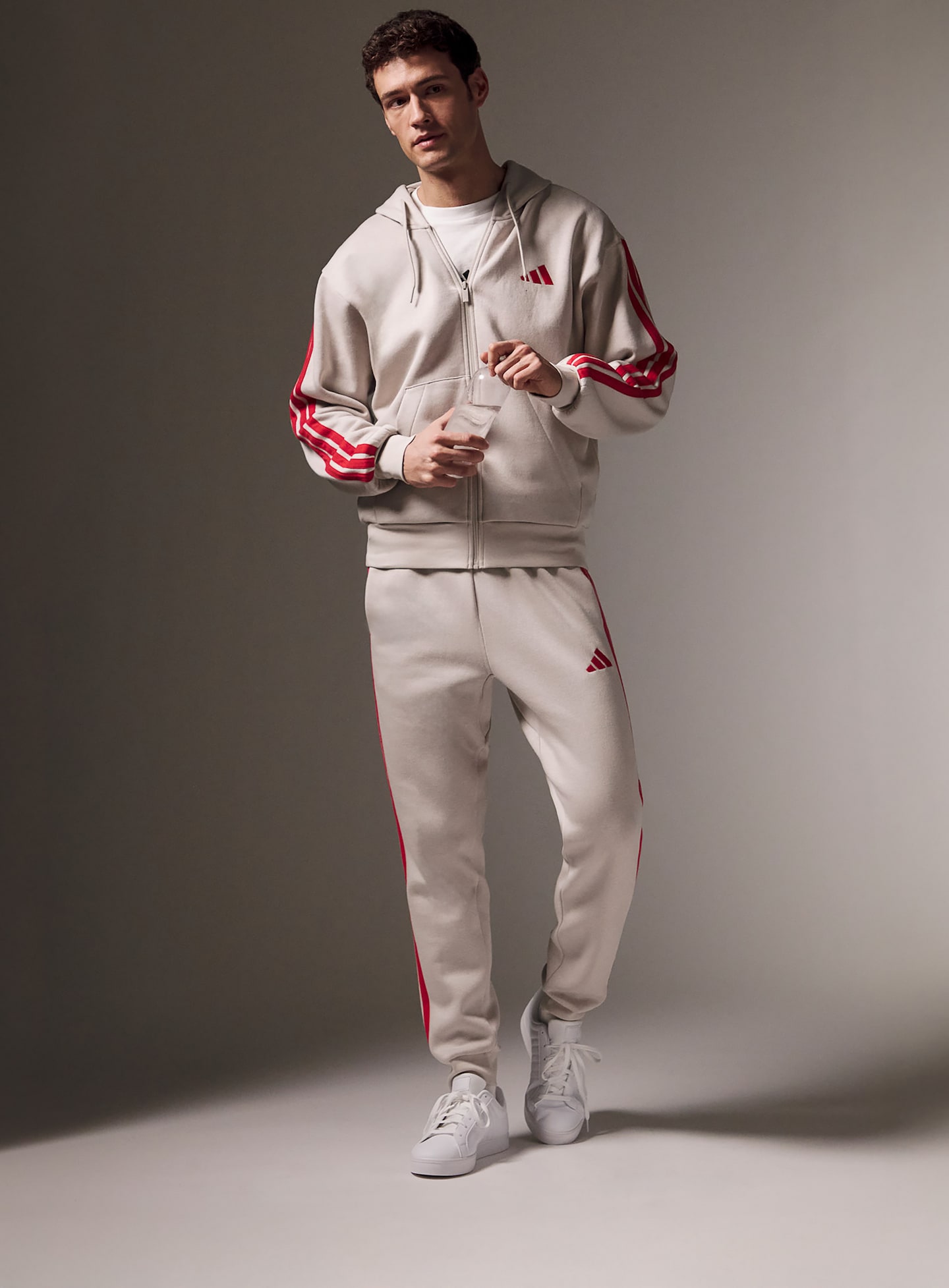 A man wearing an adidas tracksuit